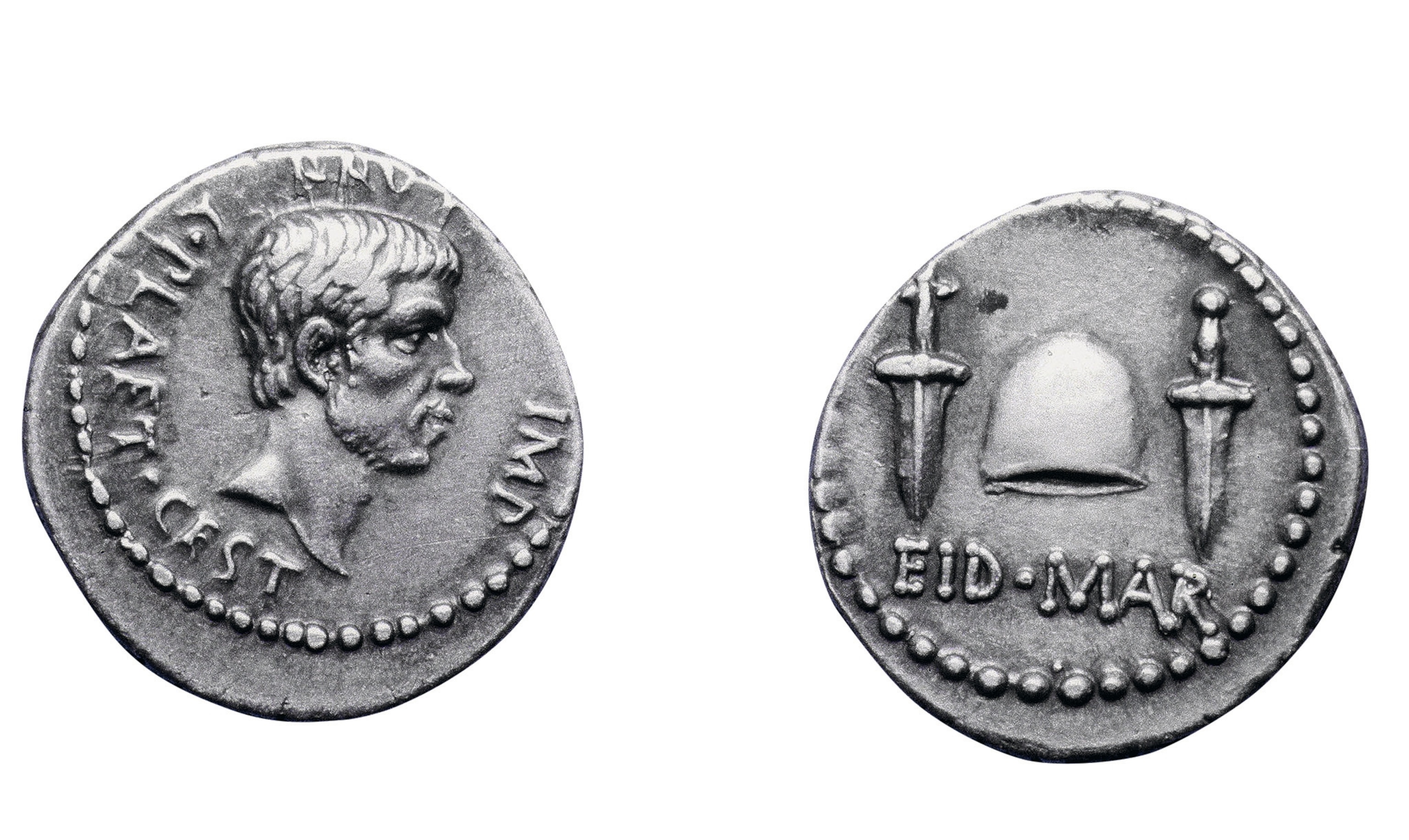 A silver denarius features Brutus’s profile on the obverse. On the reverse is the legend “Ides of March,” two daggers (the assassins’ weapons), and a pileus.