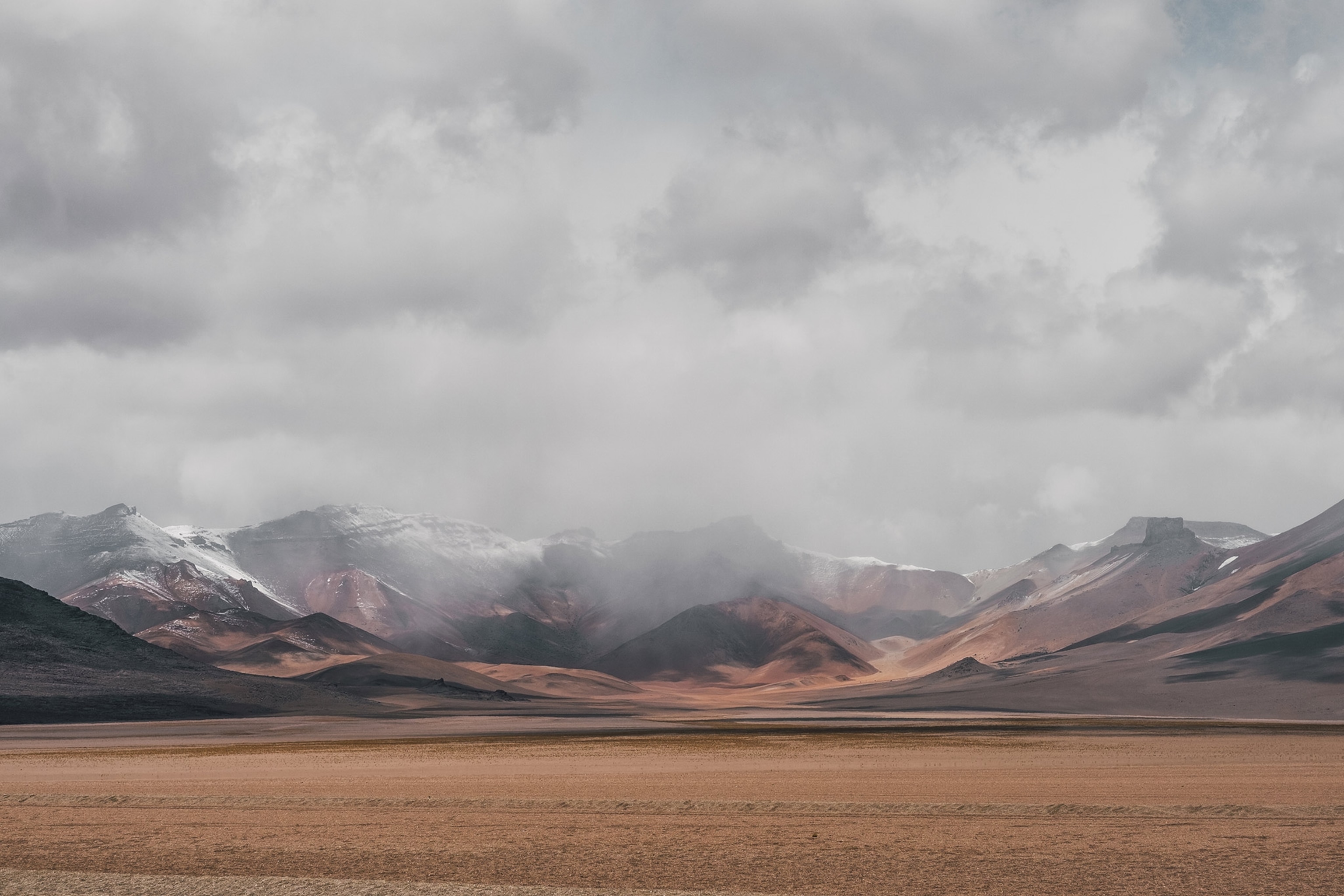 a mountain surrounded by clouds near Laguna Colorada, Bolivia
