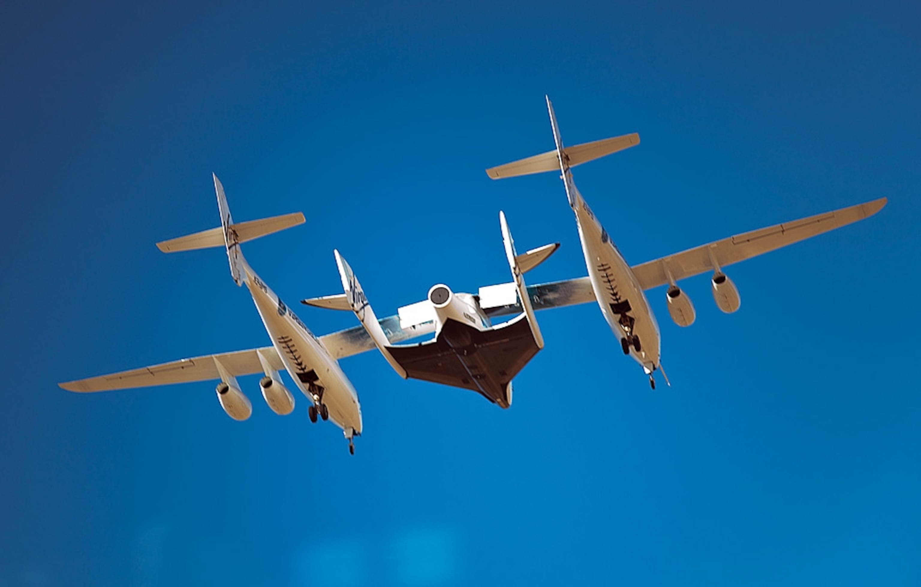 A Virgin Galactic mother ship carries the first private spaceship on a test flight.