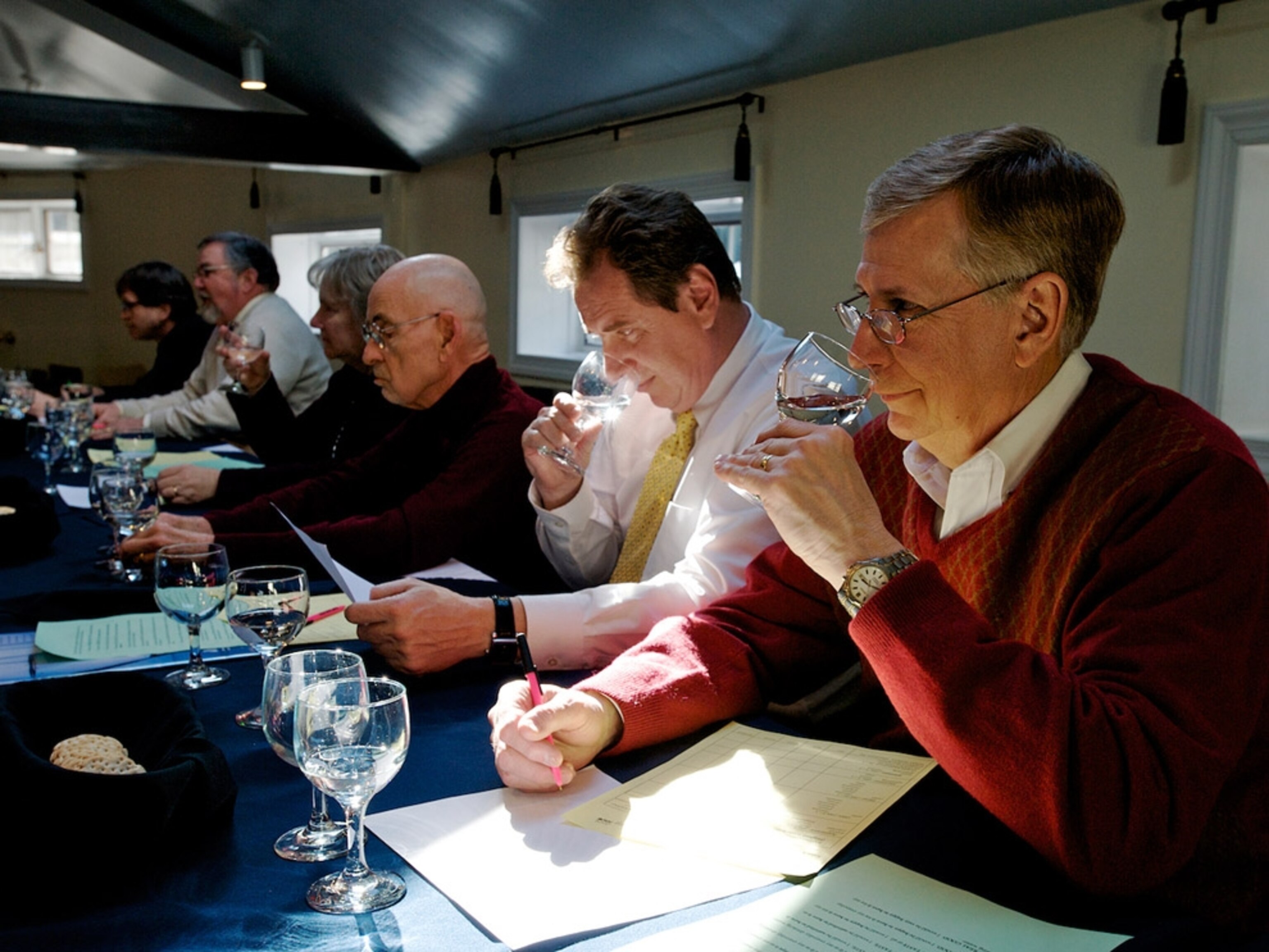 People sitting at a table tasting water