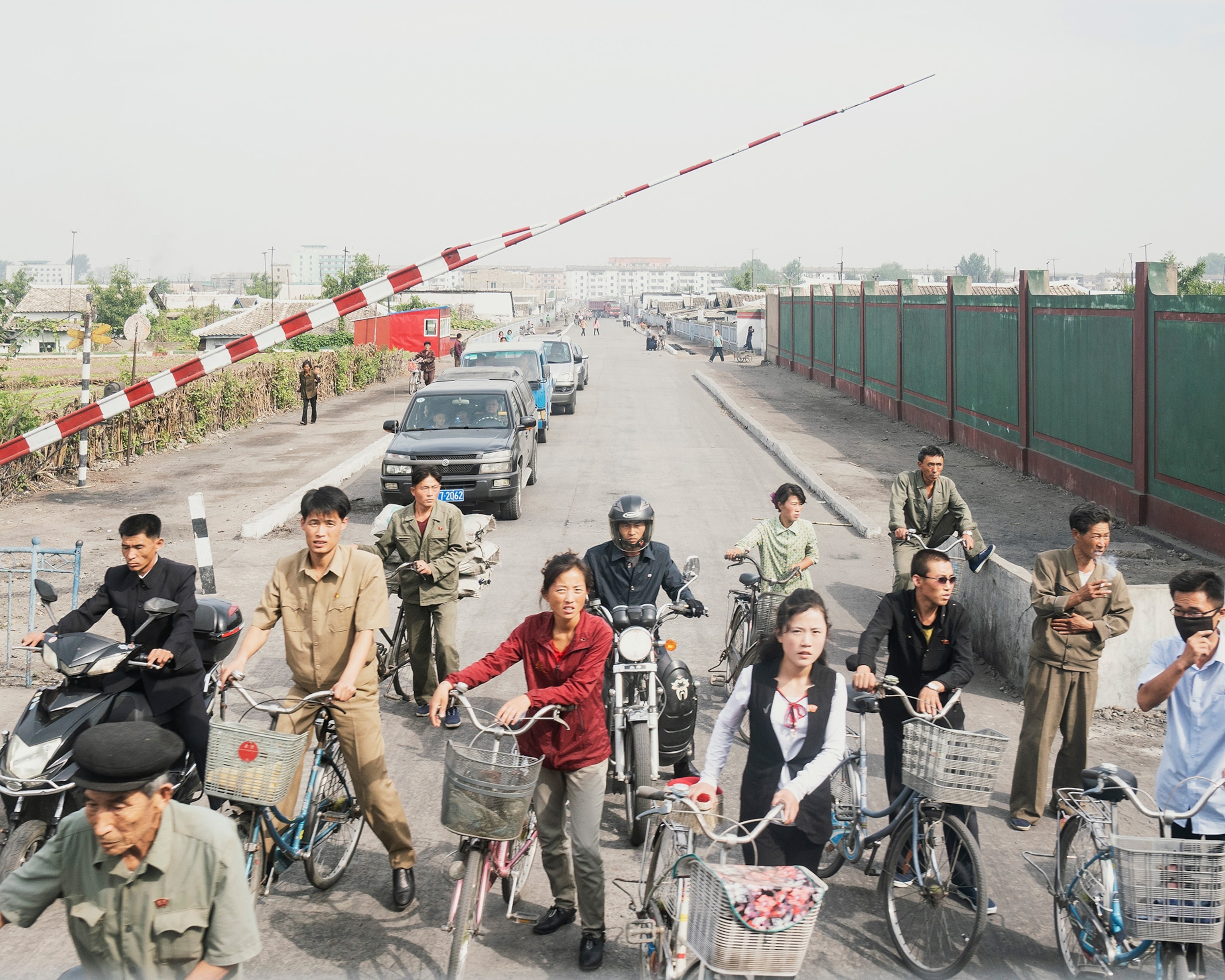 people waiting for a train to pass in North Korea