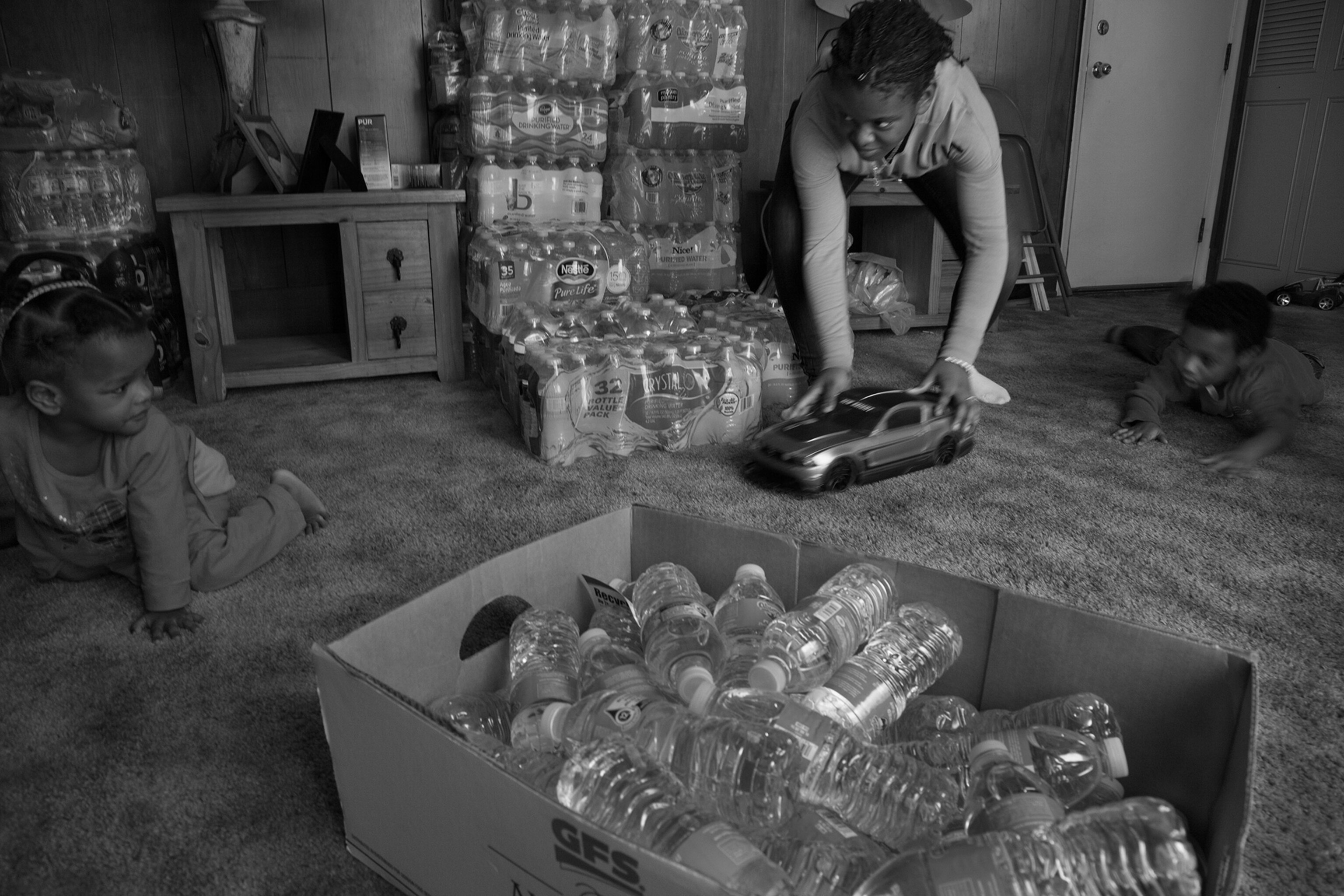 children playing in room with water bottles