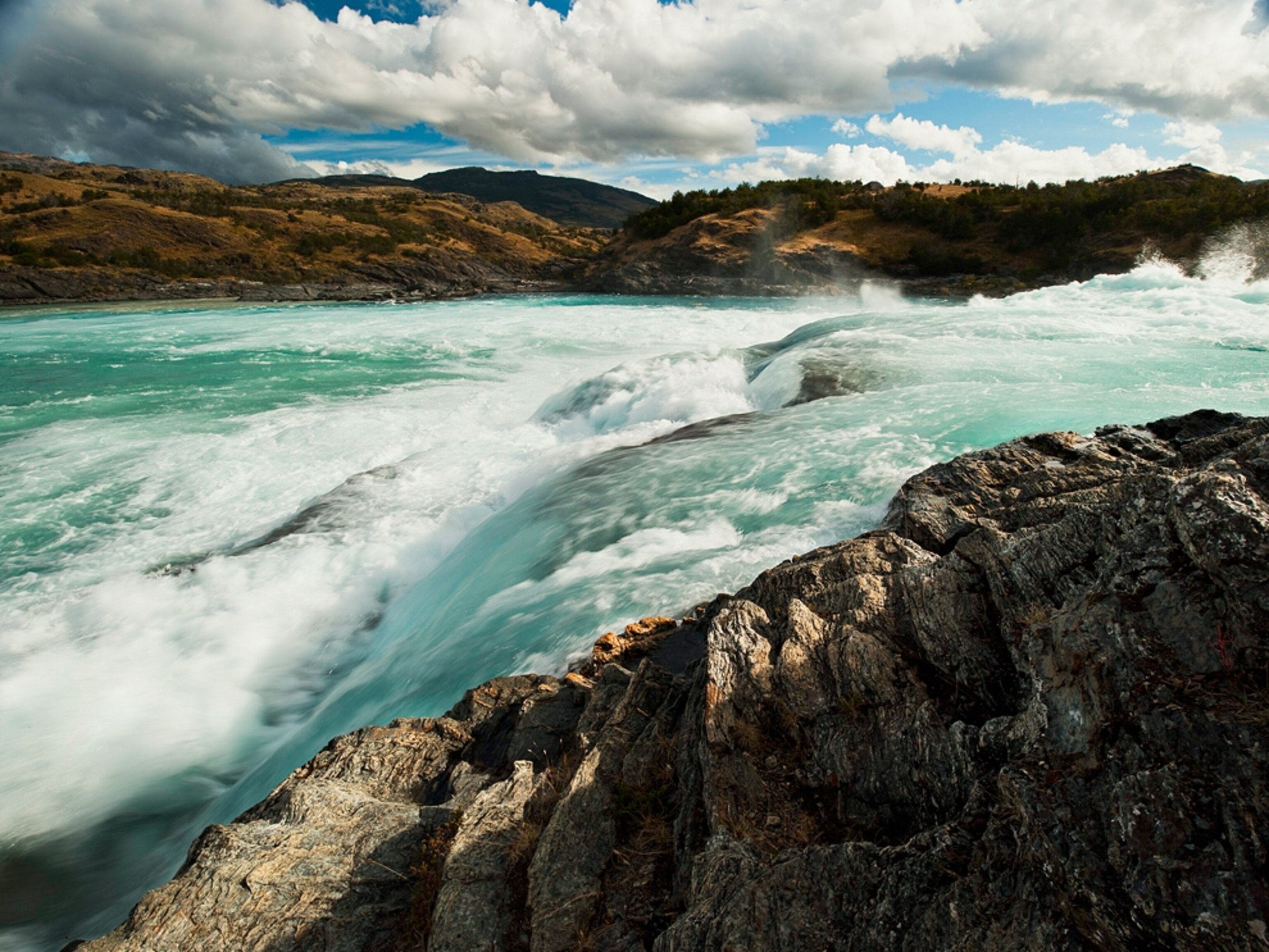 A river roars through a section of whitewater rapids