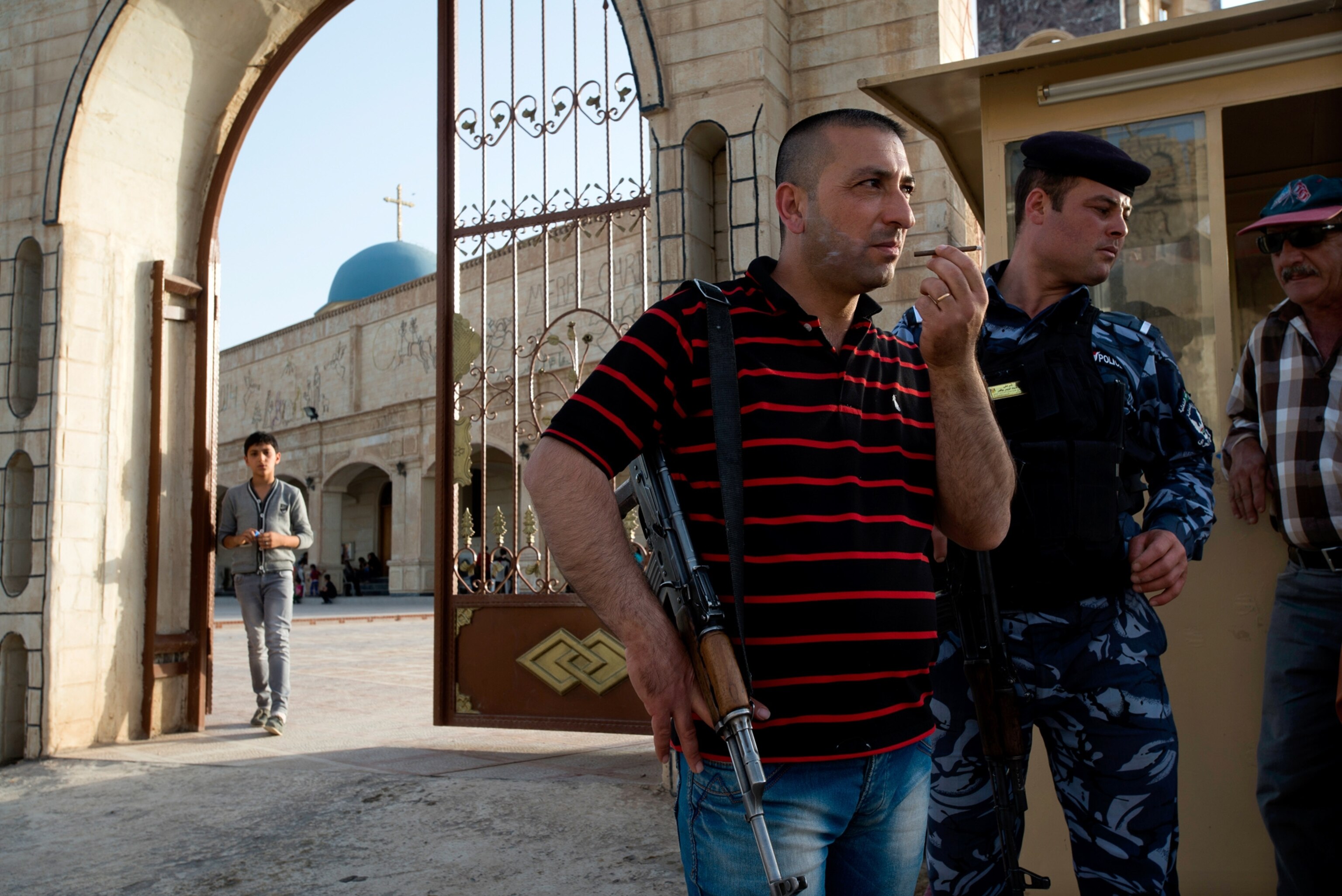 woman kissing a small boy in front of the Mar Tshmony church.