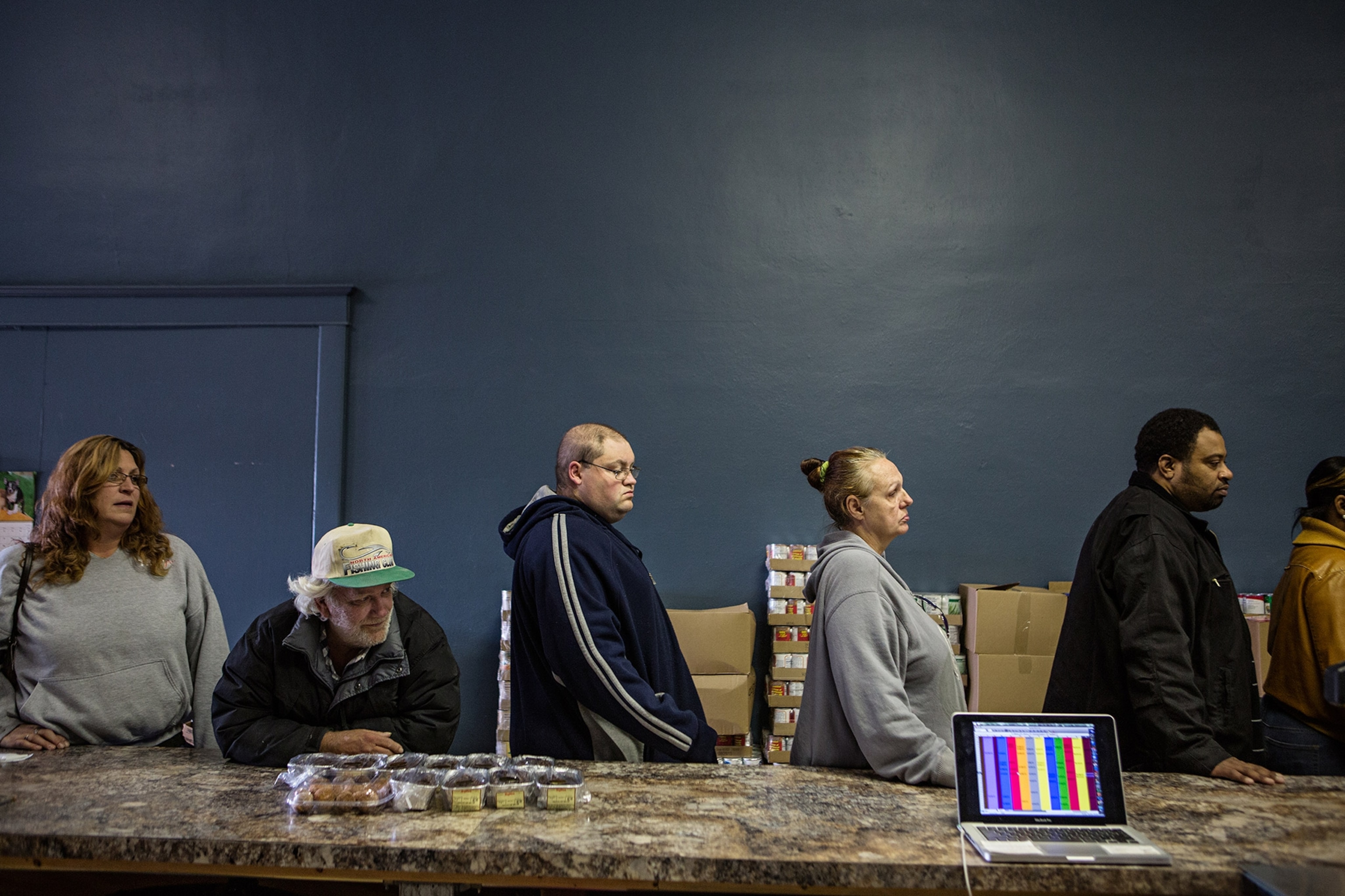 people standing in line to receive food at a food pantry
