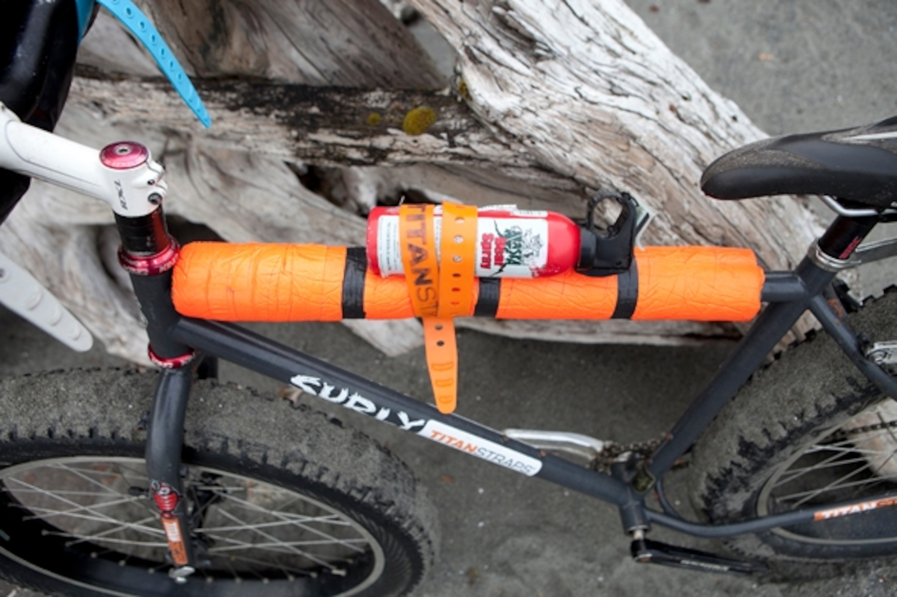 Alaska Bear Spray strapped to the top tube of our fat-tired Surly Pugsley bikes. It's wise to always have Bear Spray within hands reach; Photograph by Cameron Lawson