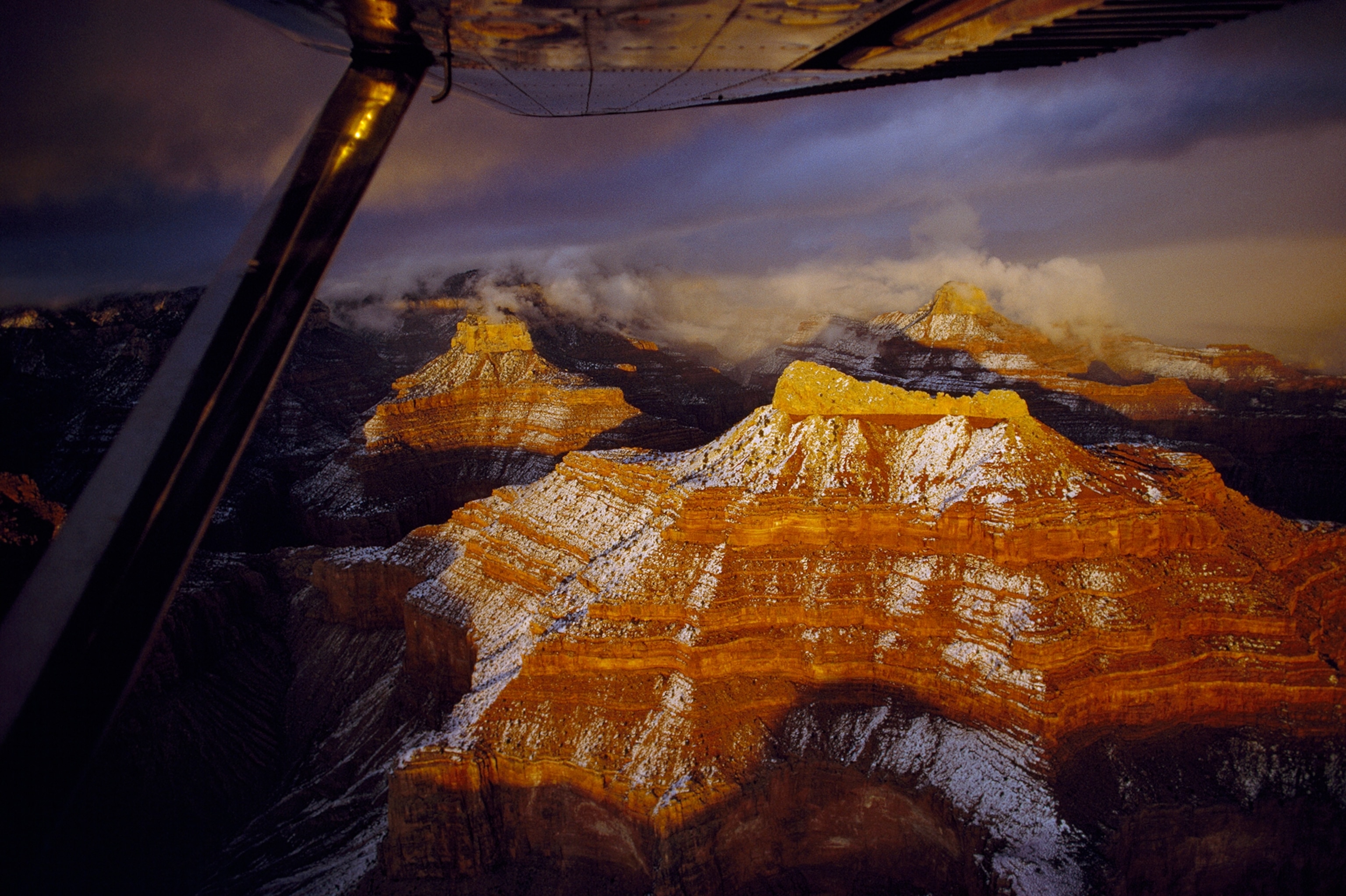 Snow-flecked Isis Temple rock formation rises from the Grand Canyon.