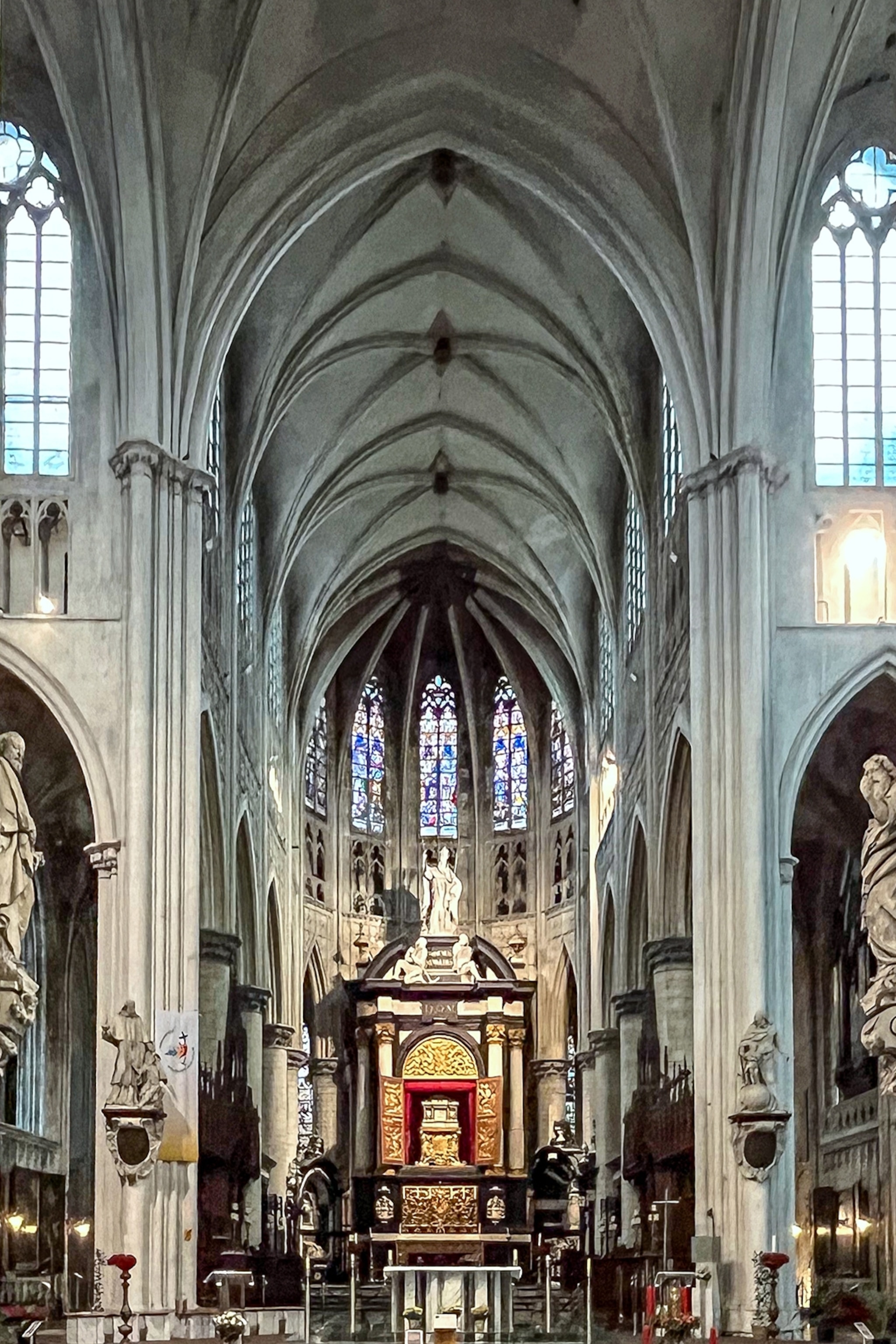 The interiors of a Gothic church with an arched stone ceiling.