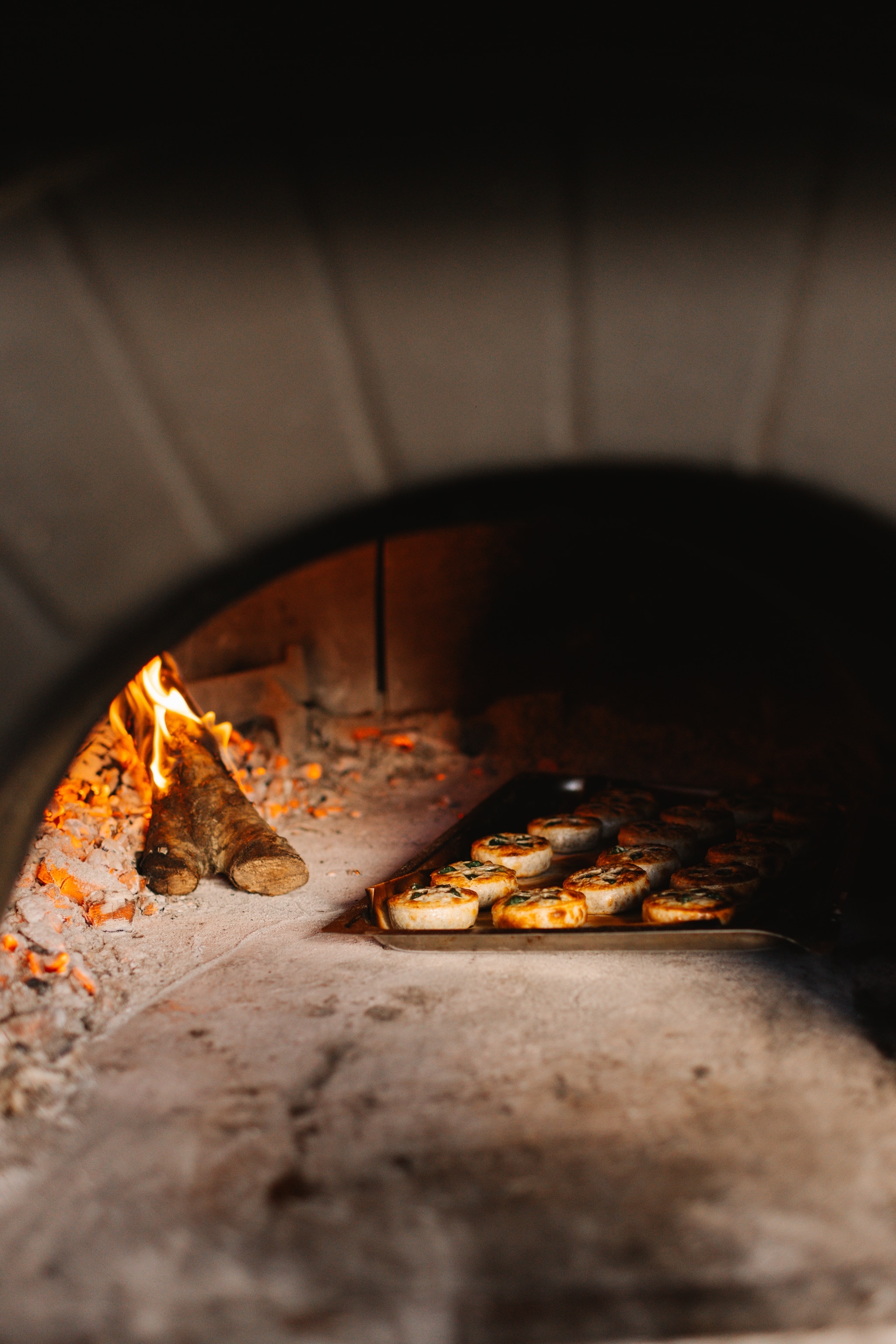 A wood-fired oven with pastries.