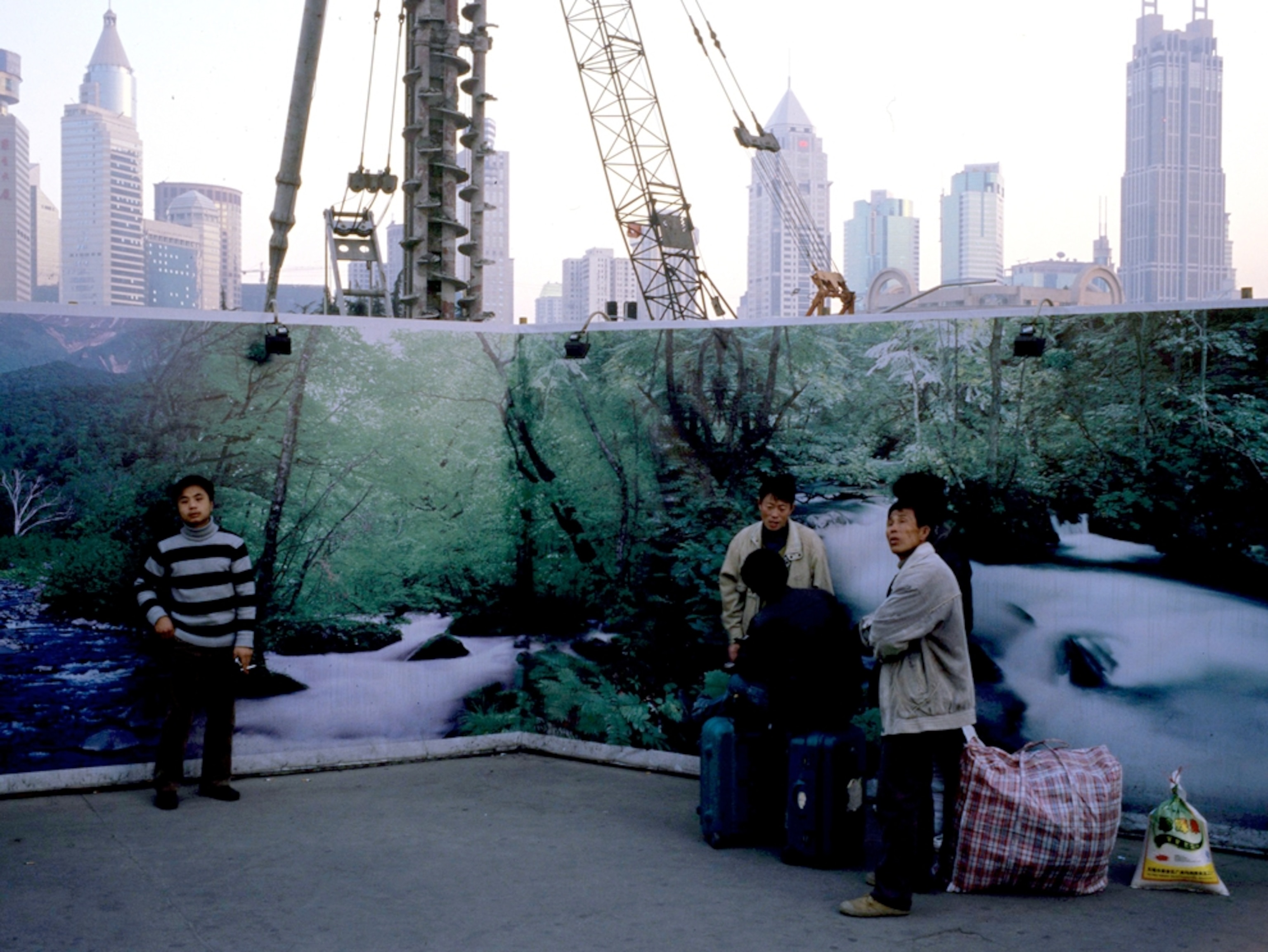 Workers standing in front of a mural