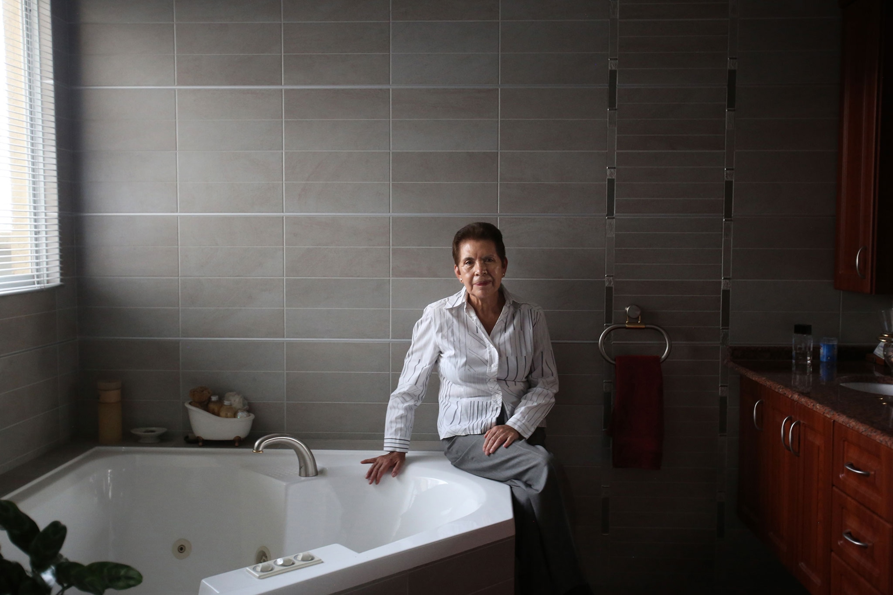 woman standing next to a bathtub