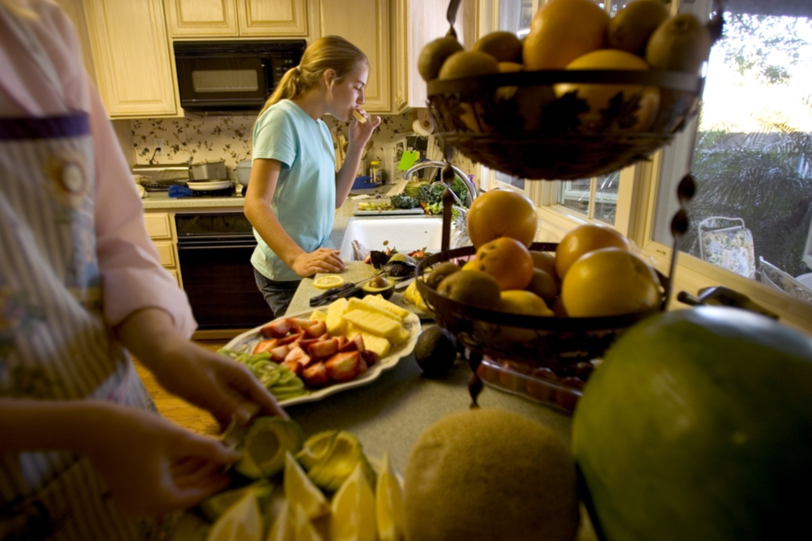 Family prepares food in the kitchen in Lomo Linda, California