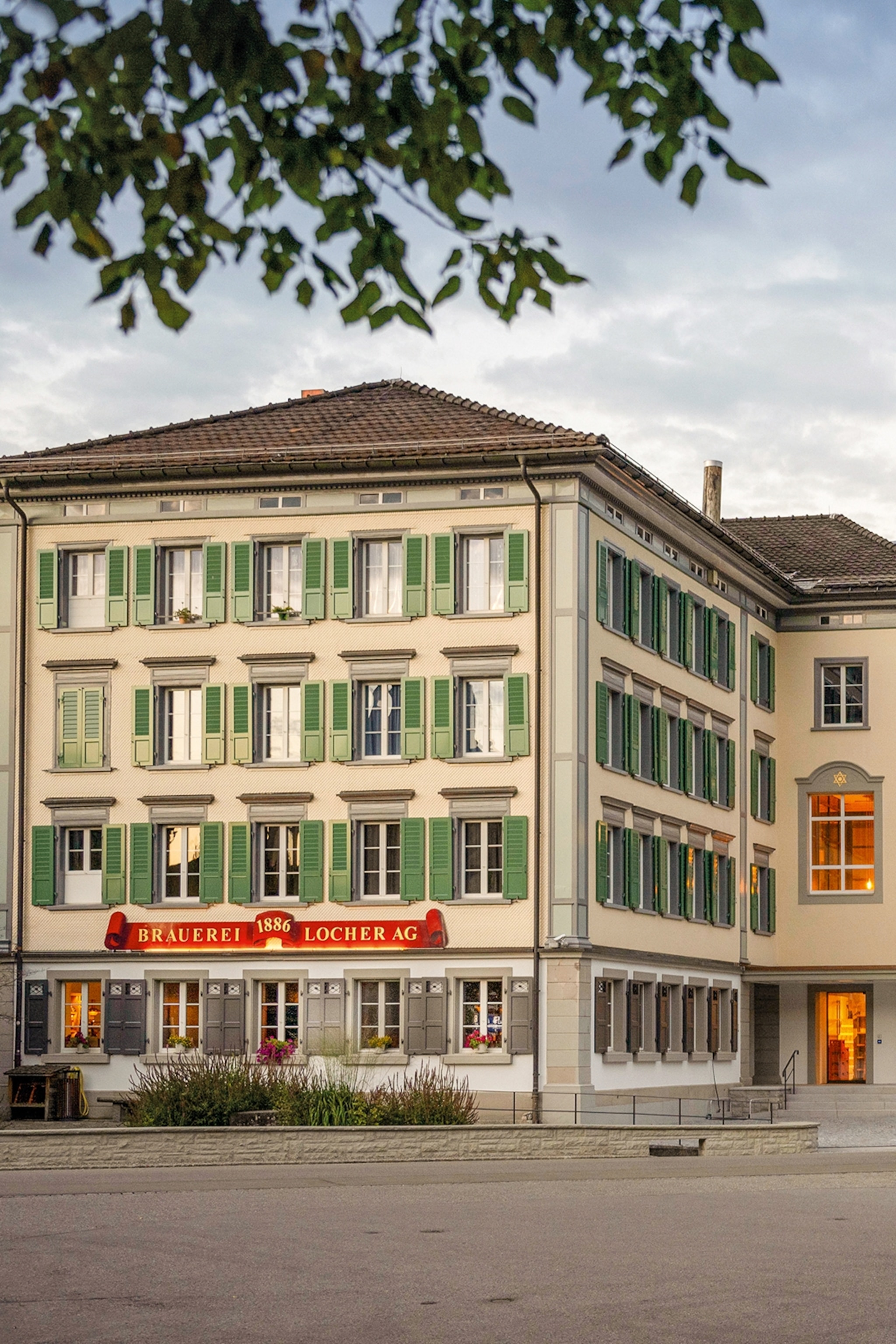 The exteriors of an opulent house with wooden window shutters.