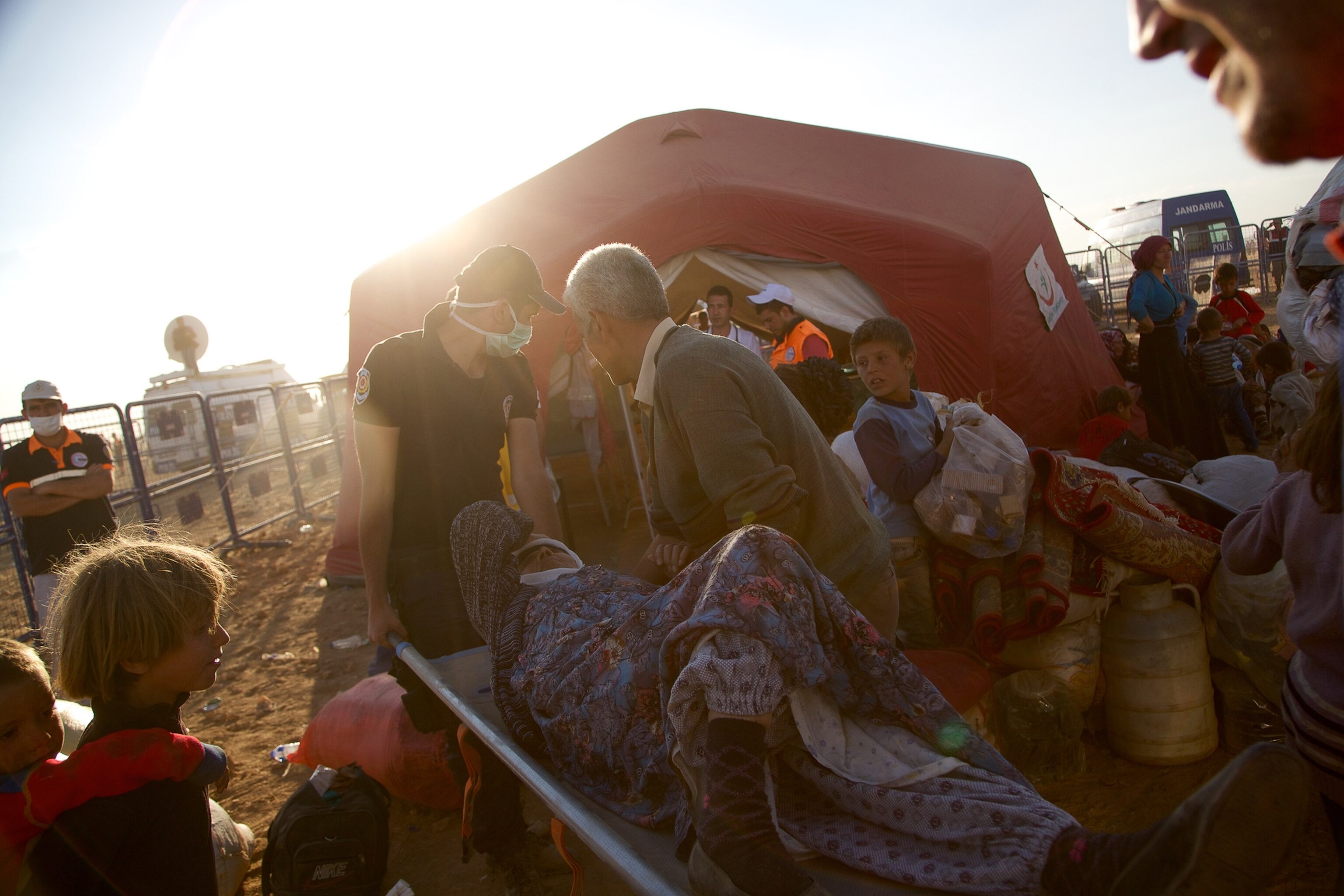 a Syrian women carrying a baby after fleeing to Turkey with thousands of others.