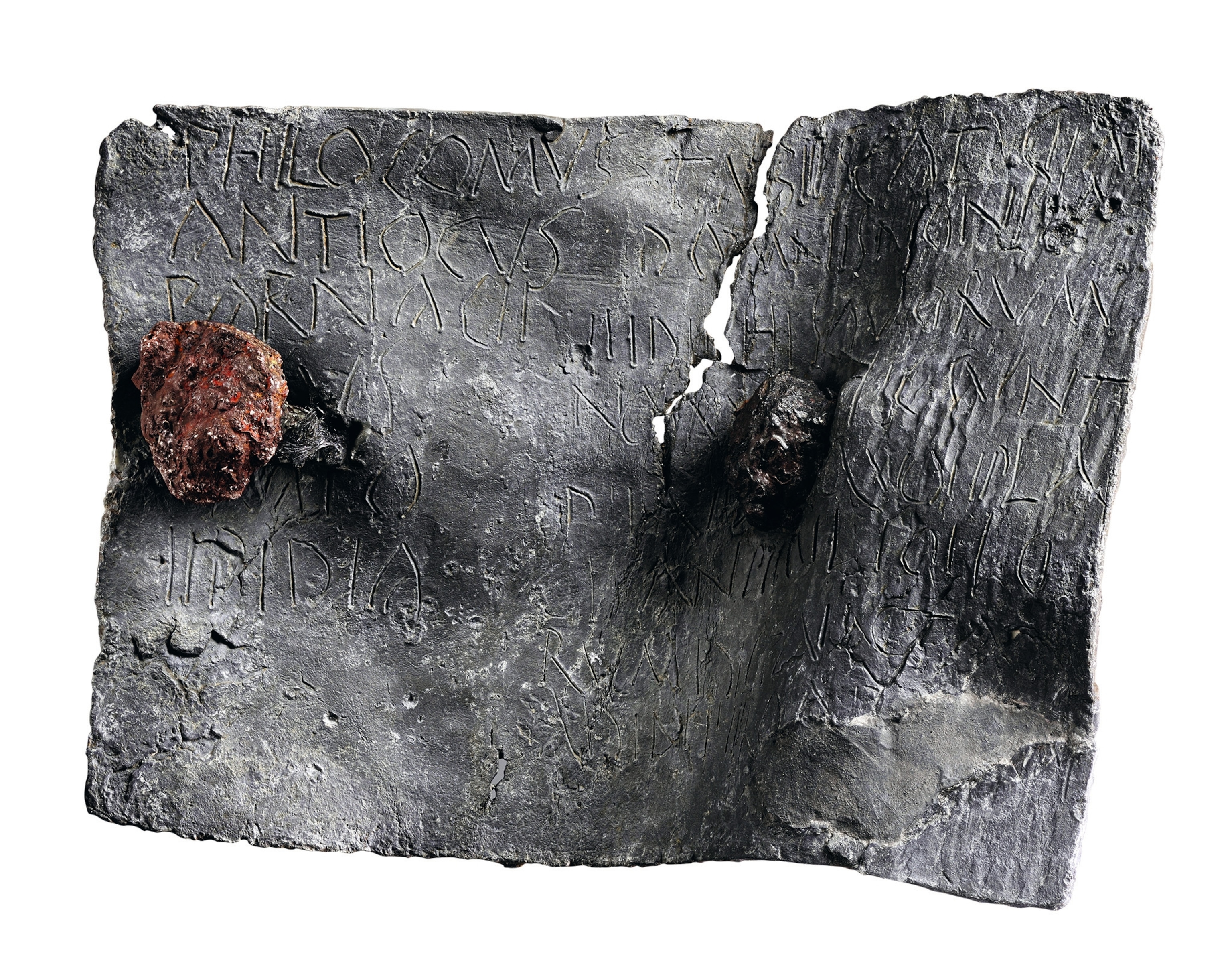 A lead sheet is inscribed with a curse and fixed with two nails.