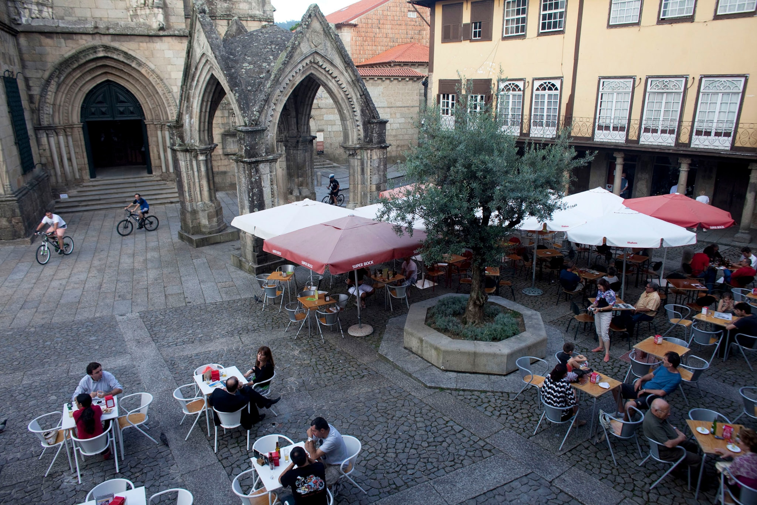 Local residents and tourists hang out in Praca da Oliveira in the old part of Guimaraes.