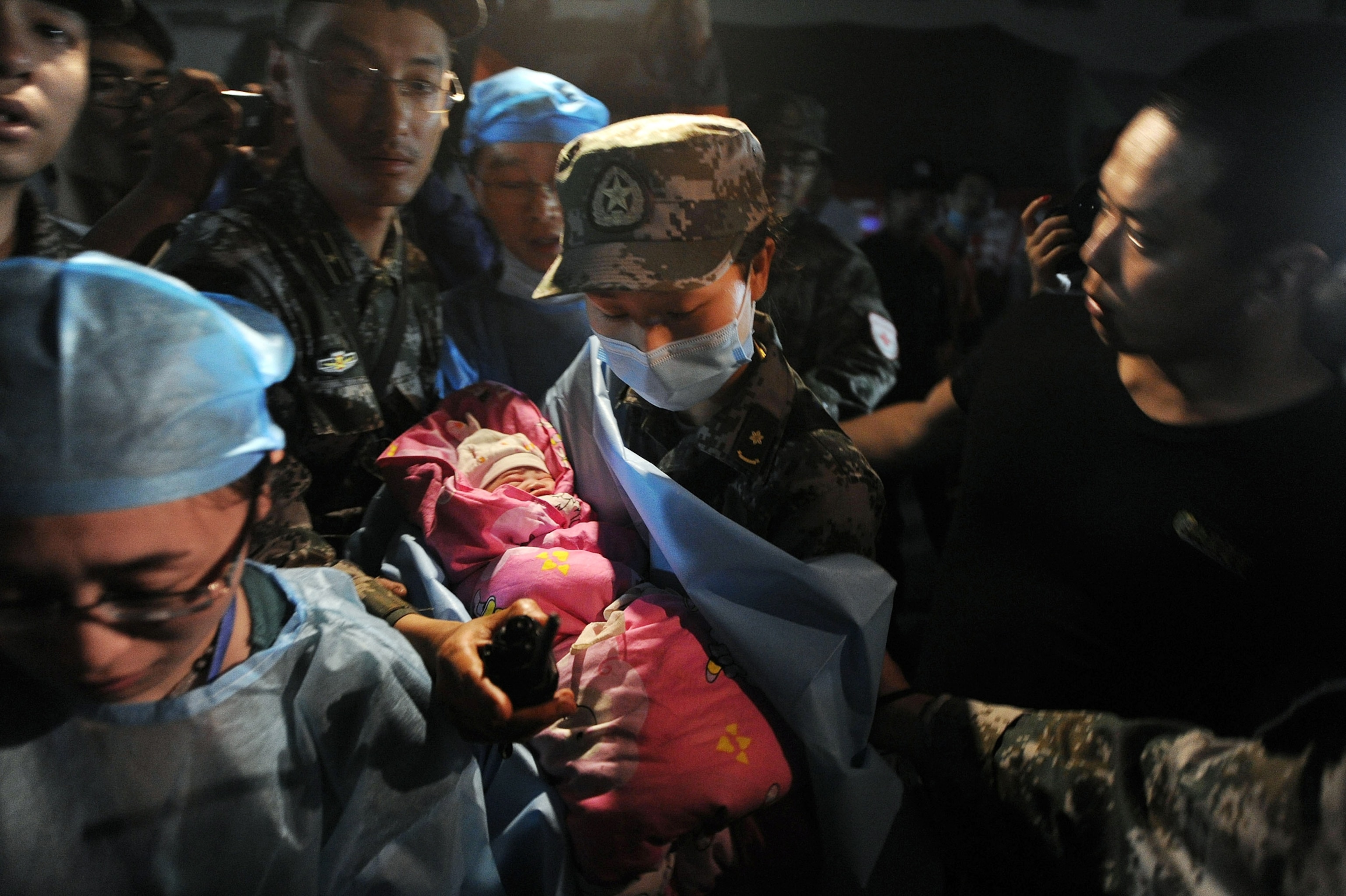 medical staff attending to a baby after an earthquake in China.