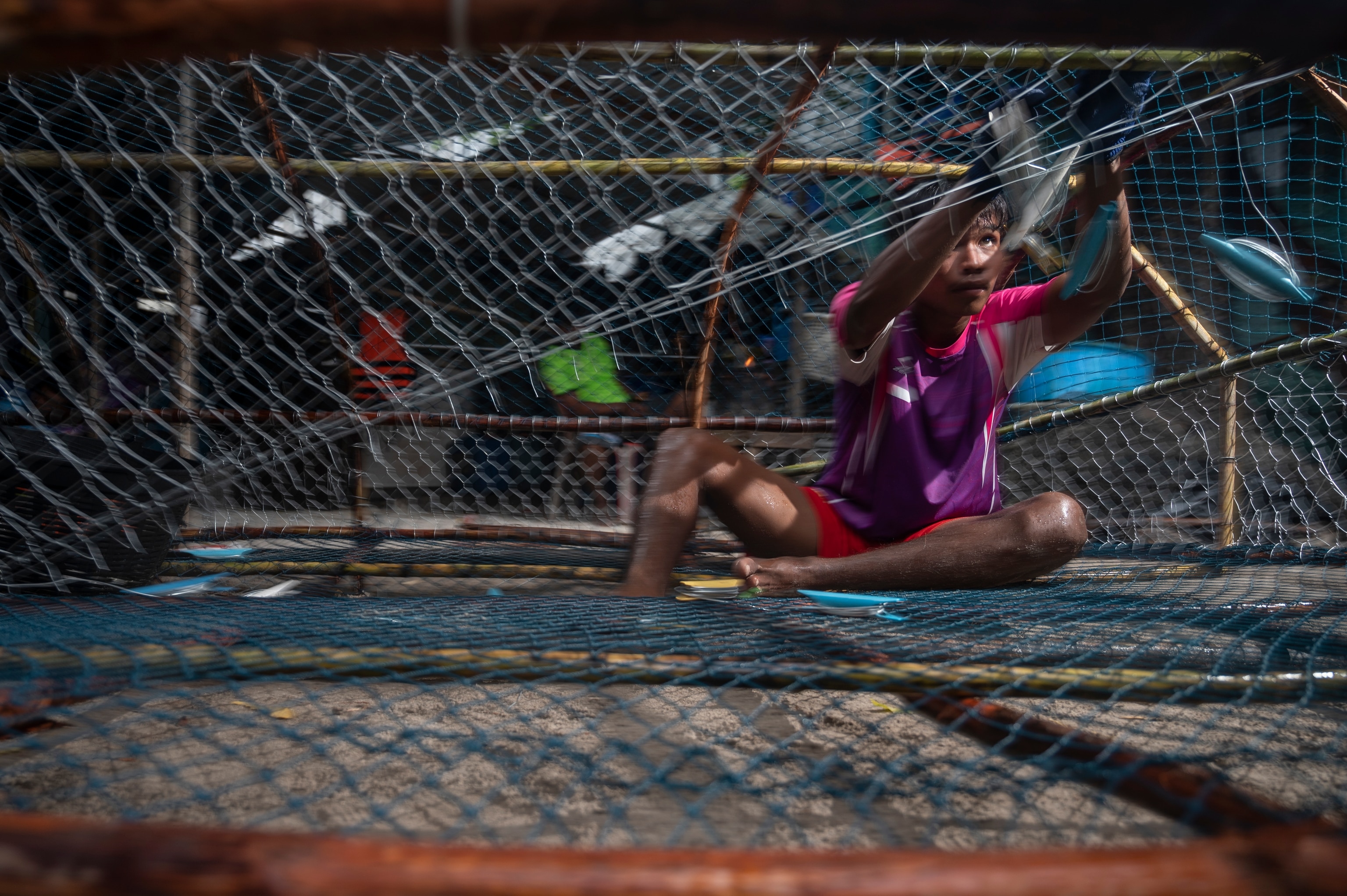 Image of Urak Lawoi teenager weaving fish trap in Koh Lipe