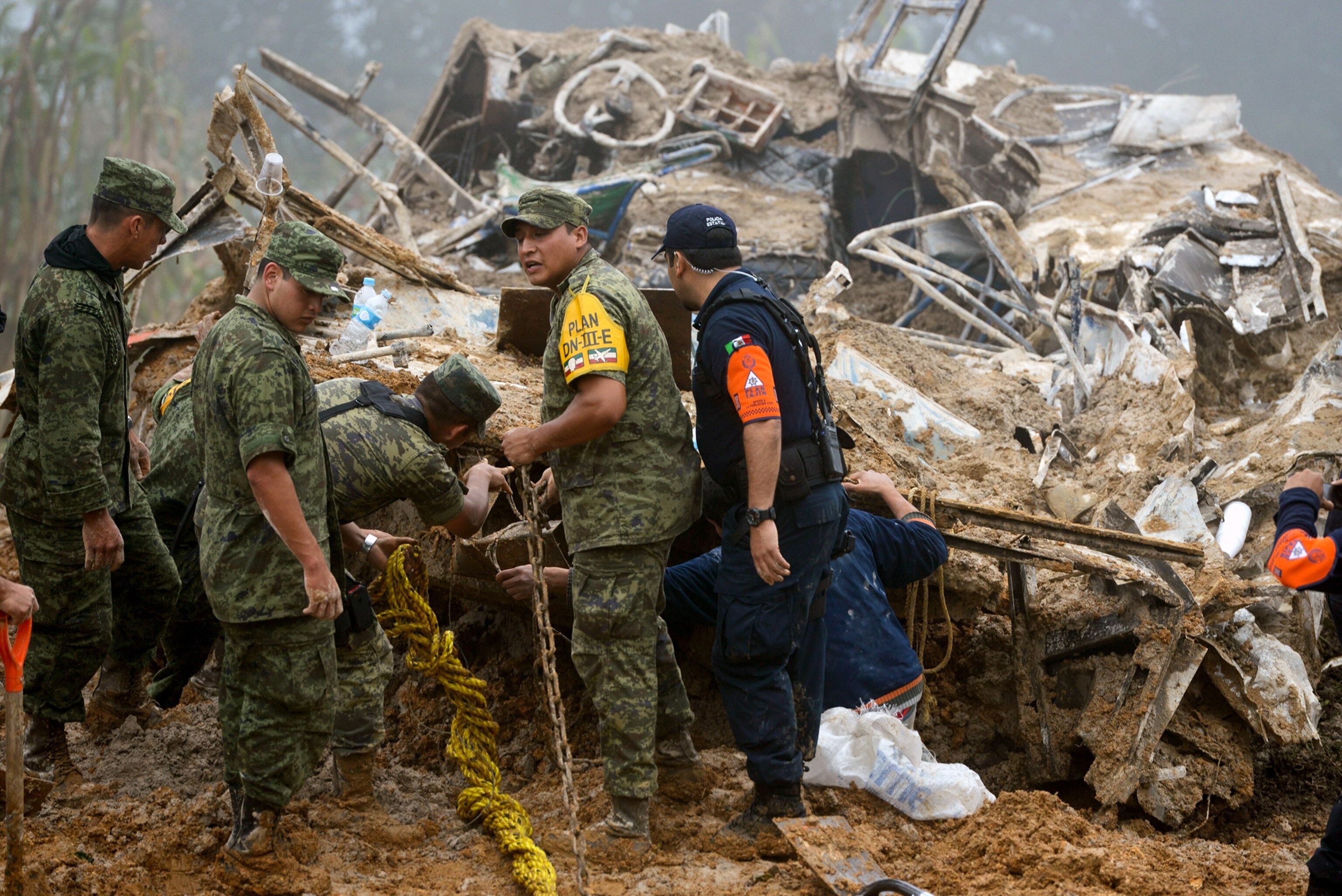 soldiers and police searching for survivors of a landslide in Veracruz, Mexico