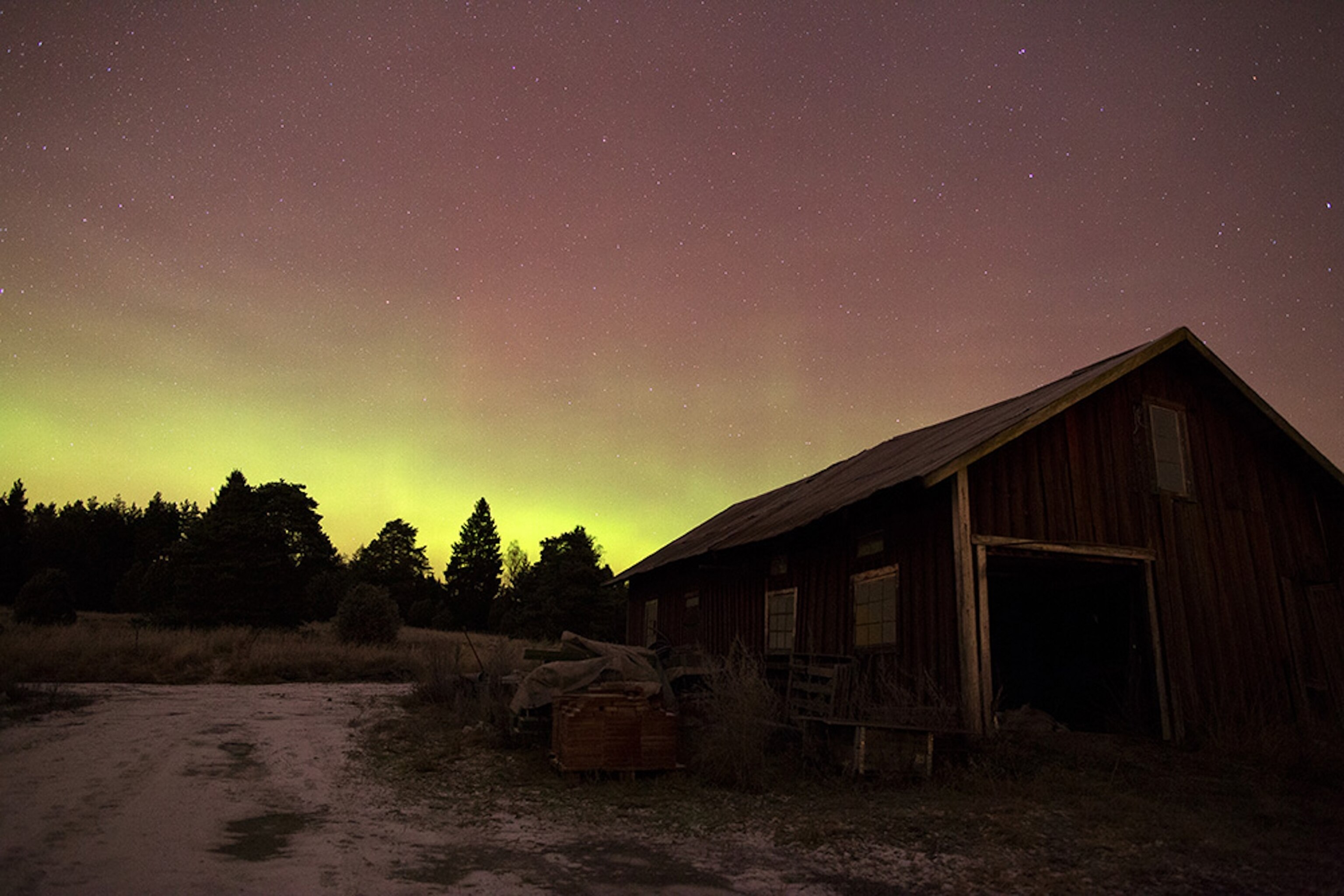 the Aurora Borealis over a cabin in Sweden.