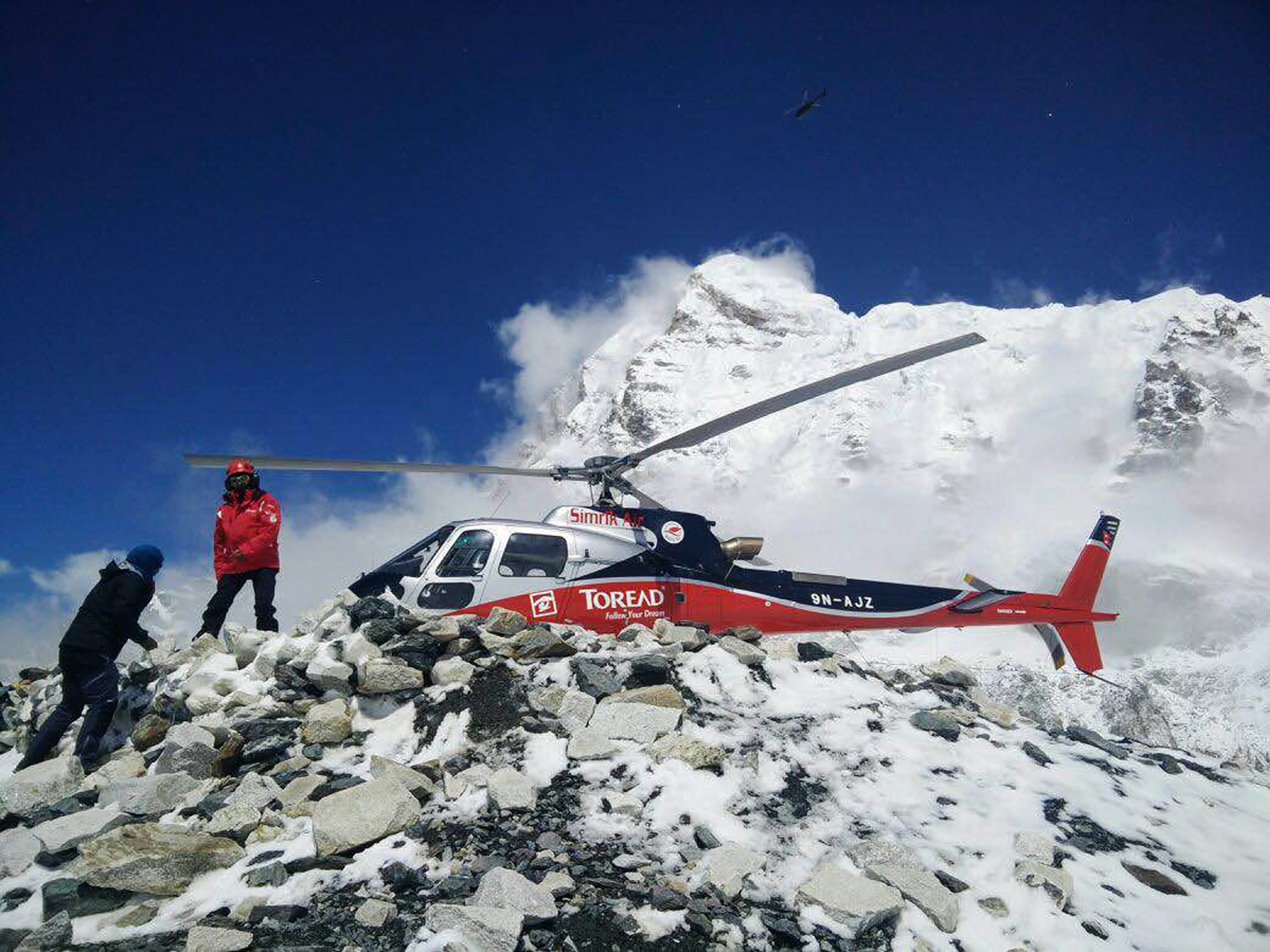 a helicopter prepares to rescue people from camp 1 and 2 at Everest Base Camp