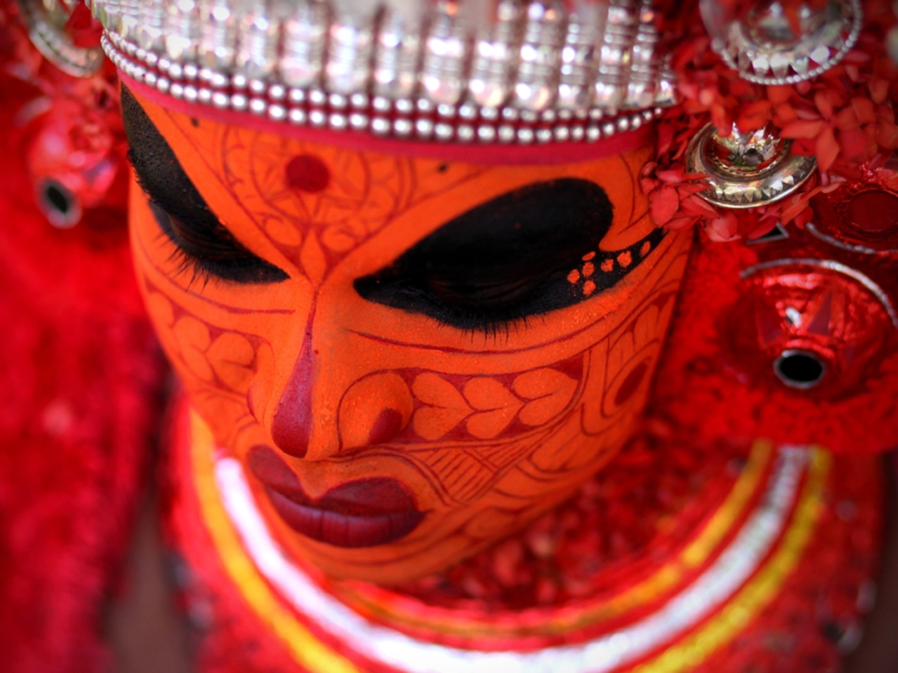 a dancer preparing for the Theyyam performance in the surroundings of Kasaragod city