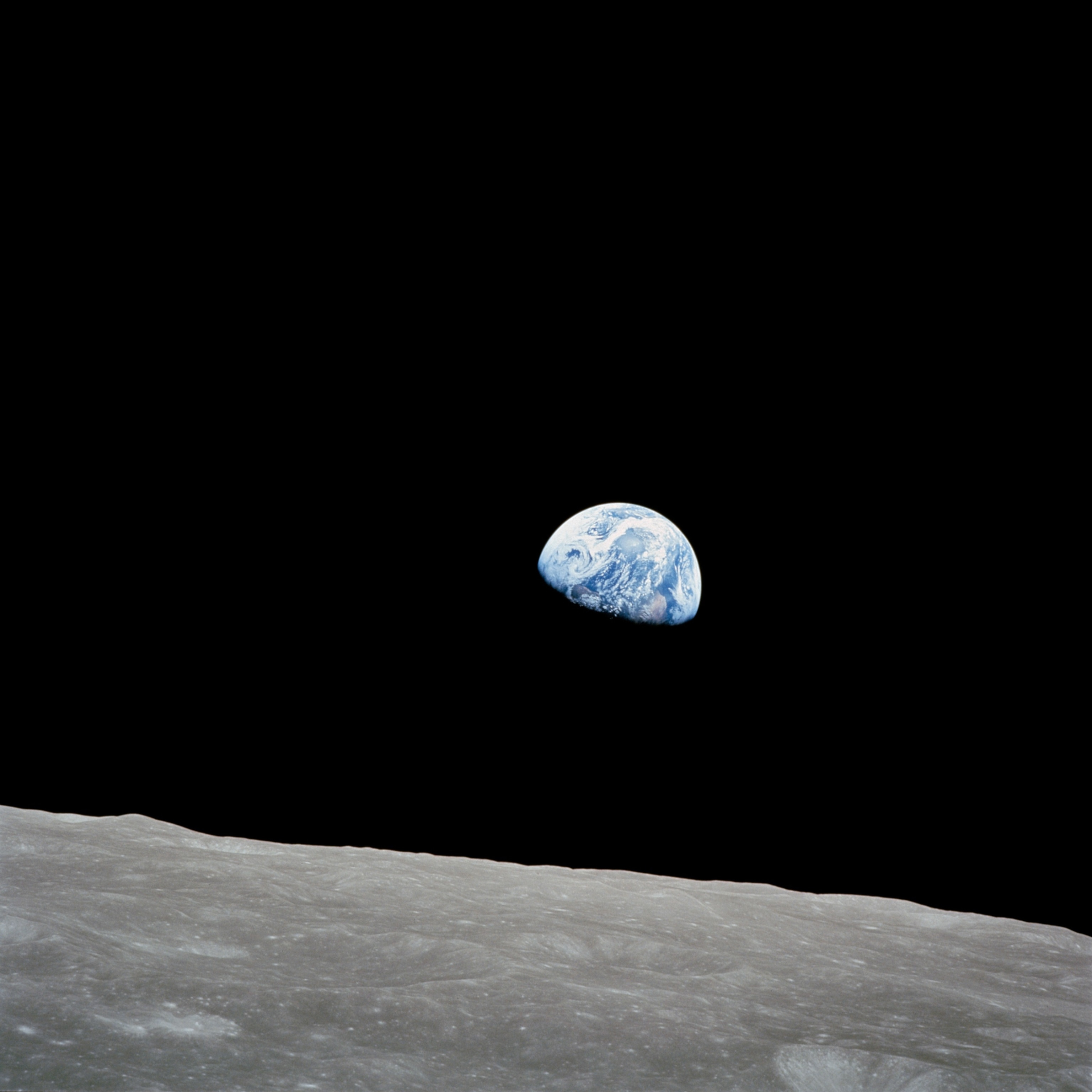 The Earth rising above the Moon's surface
