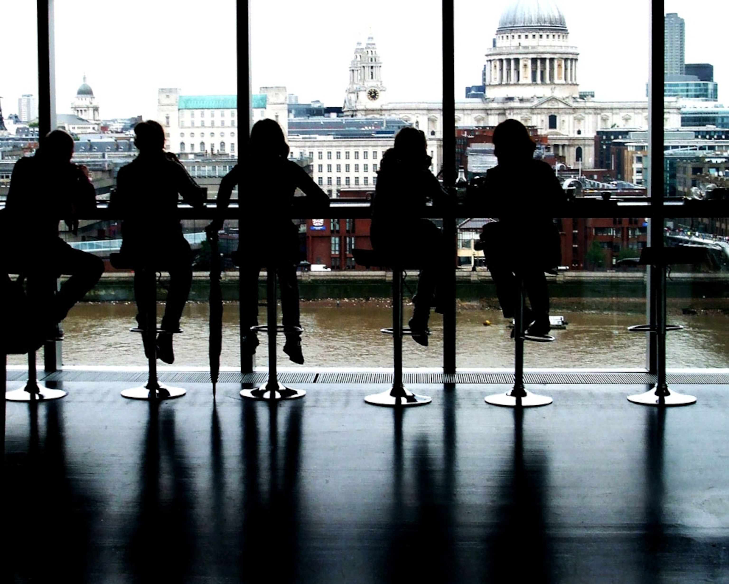 Silhouetted figures at a cafe counter