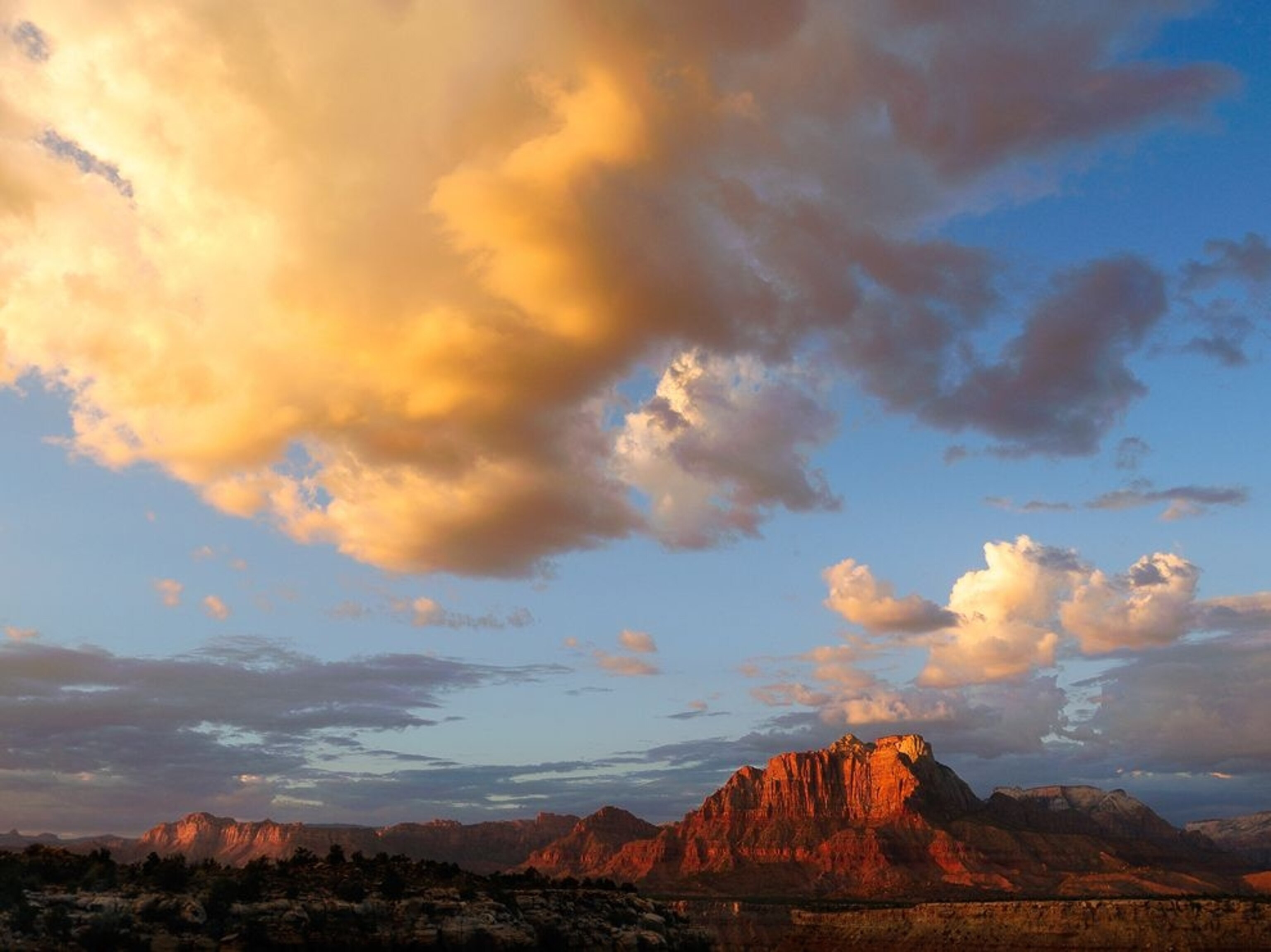 clouds above red rock formations