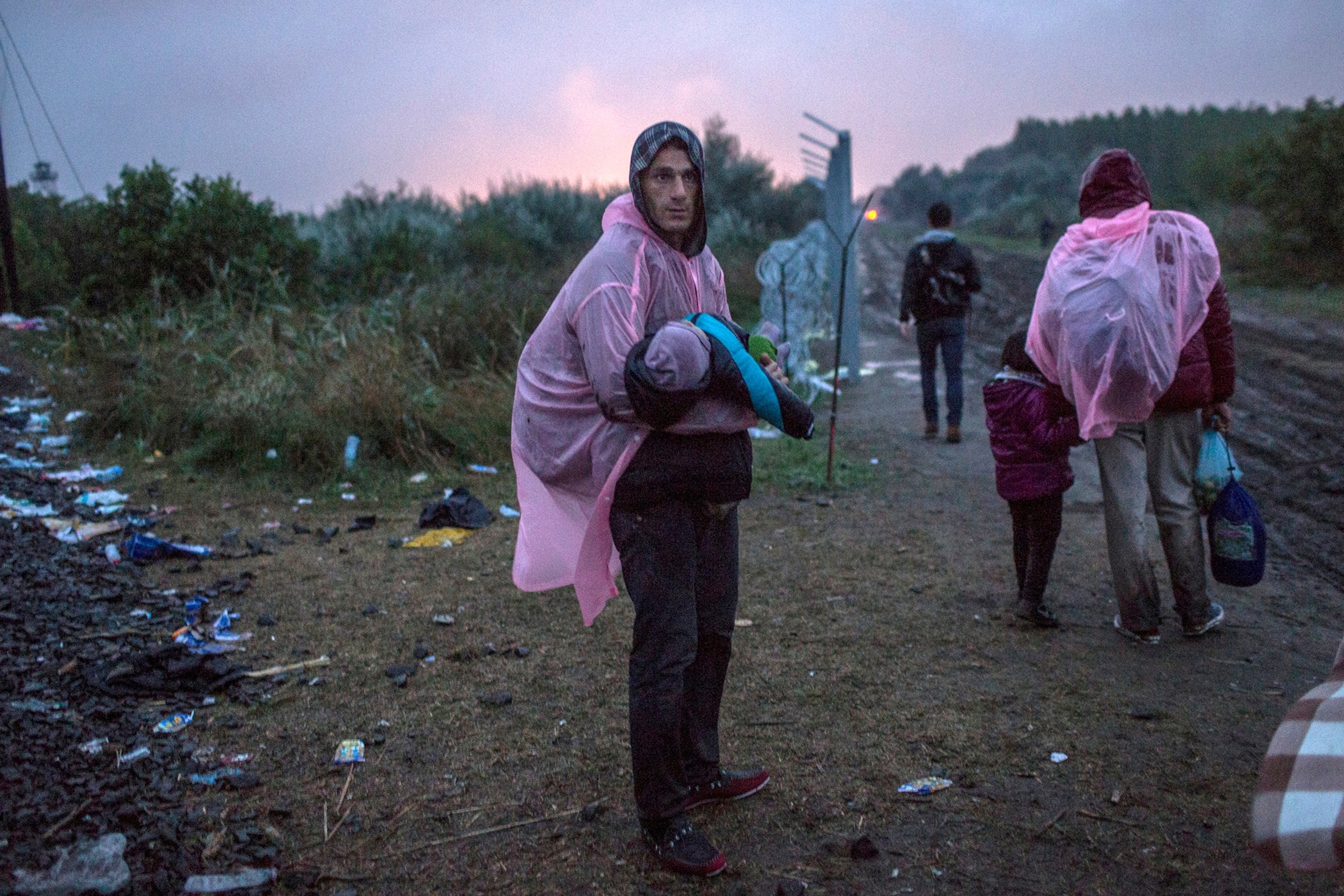 refugees cross the Hungarian-Serbian border near the town of Roske, Hungary