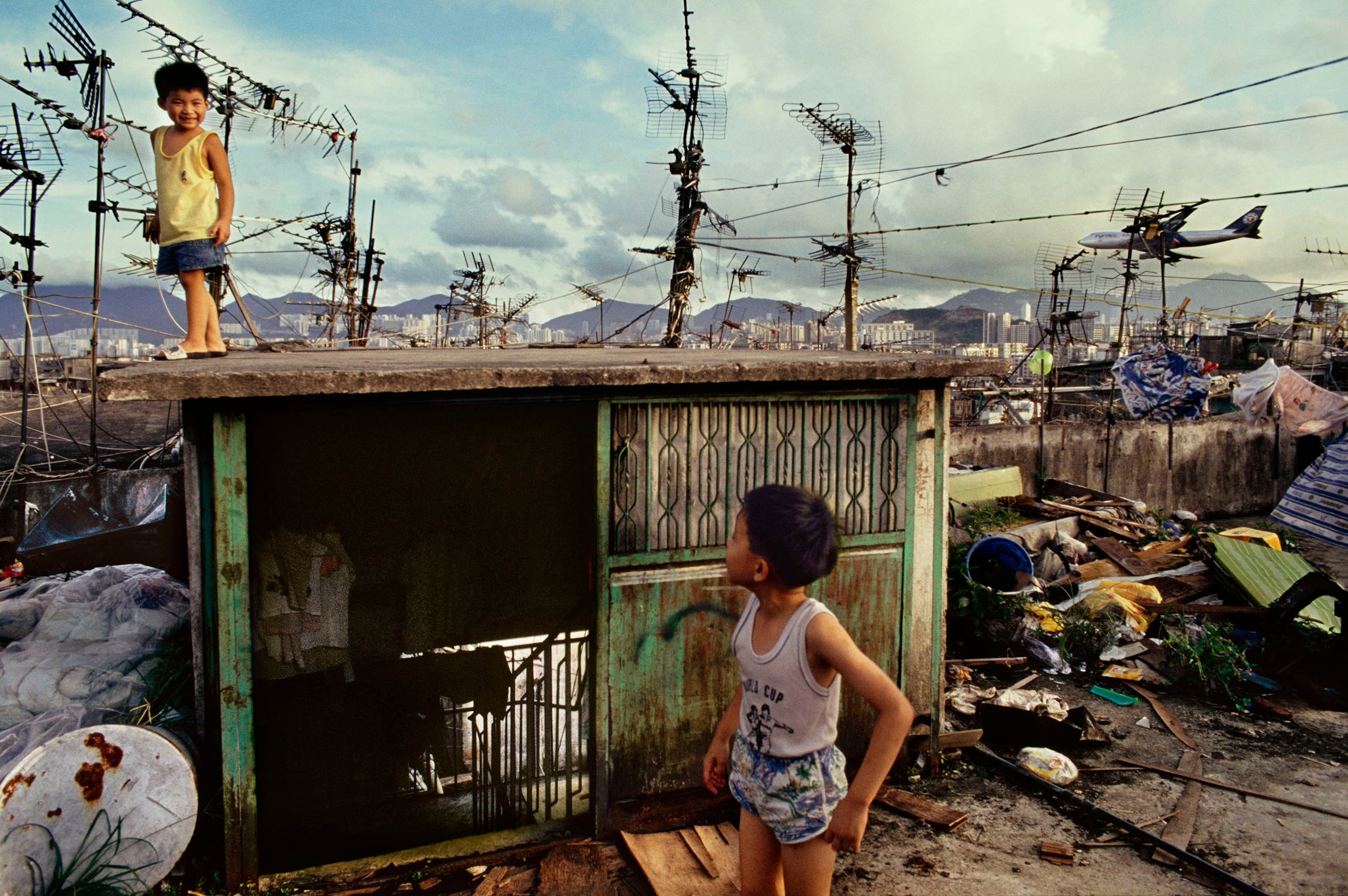 Two children play on a rooftop.