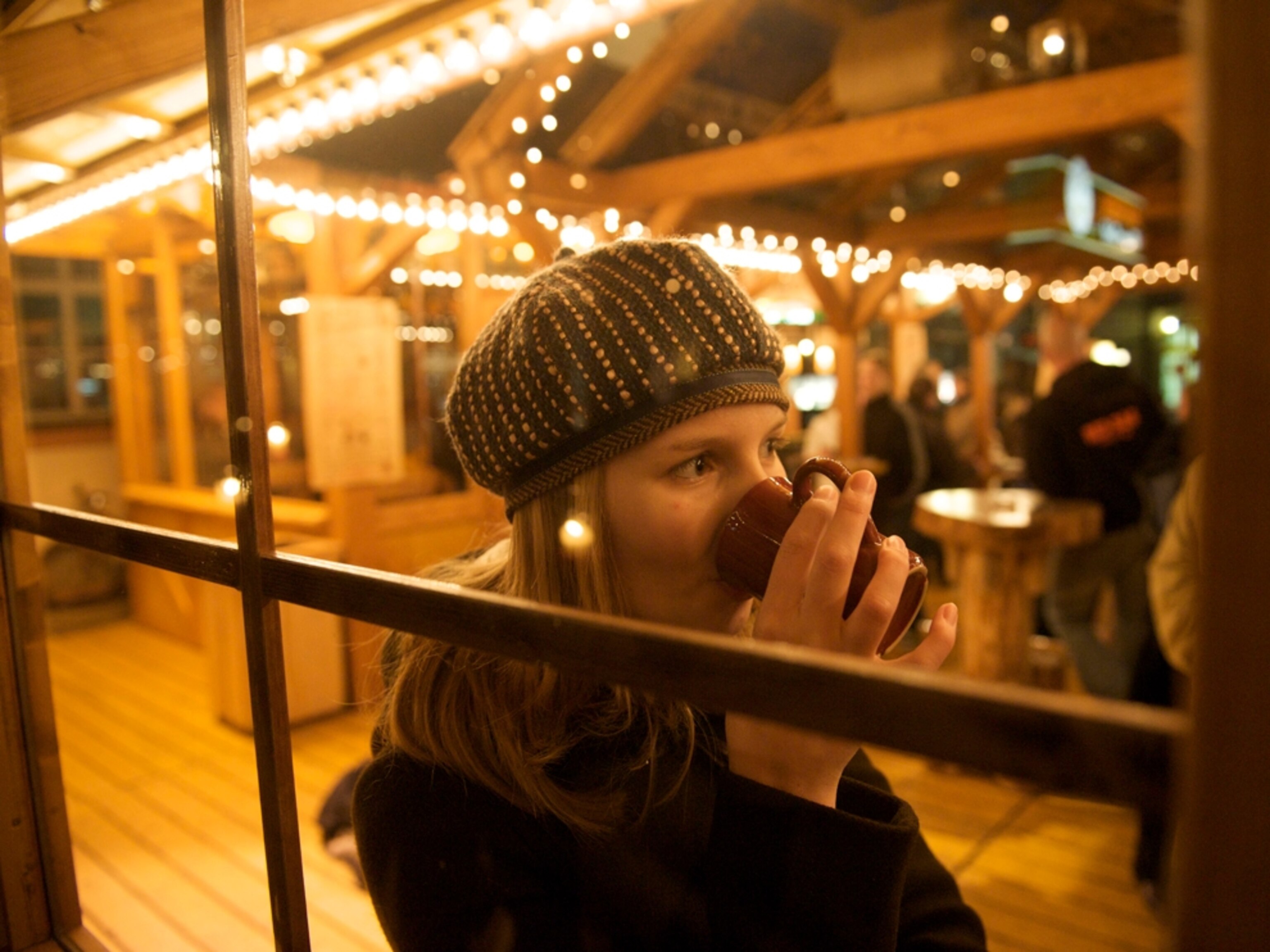 girl drinking at a german holiday market