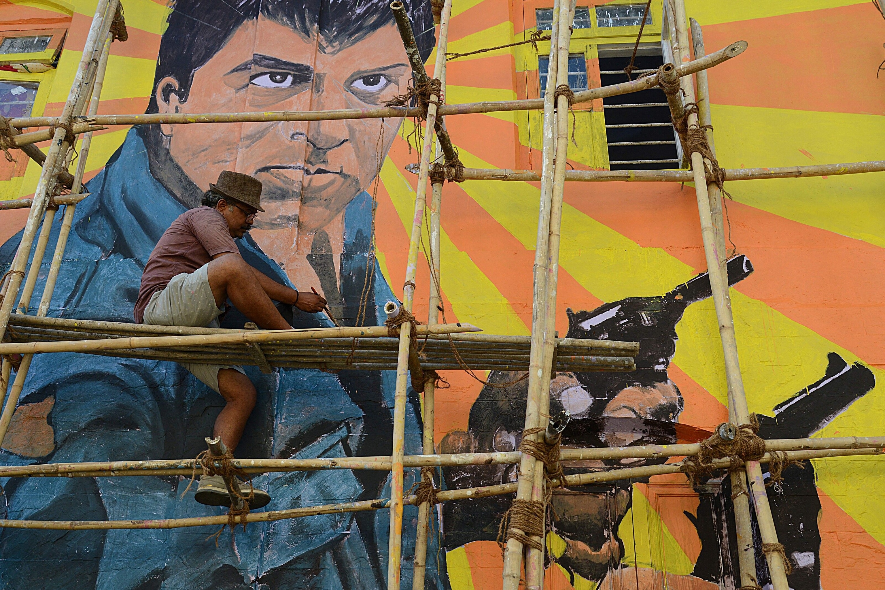 Artist Ranjit Dahiya paints a mural of actor Dharmendra in Bandra.