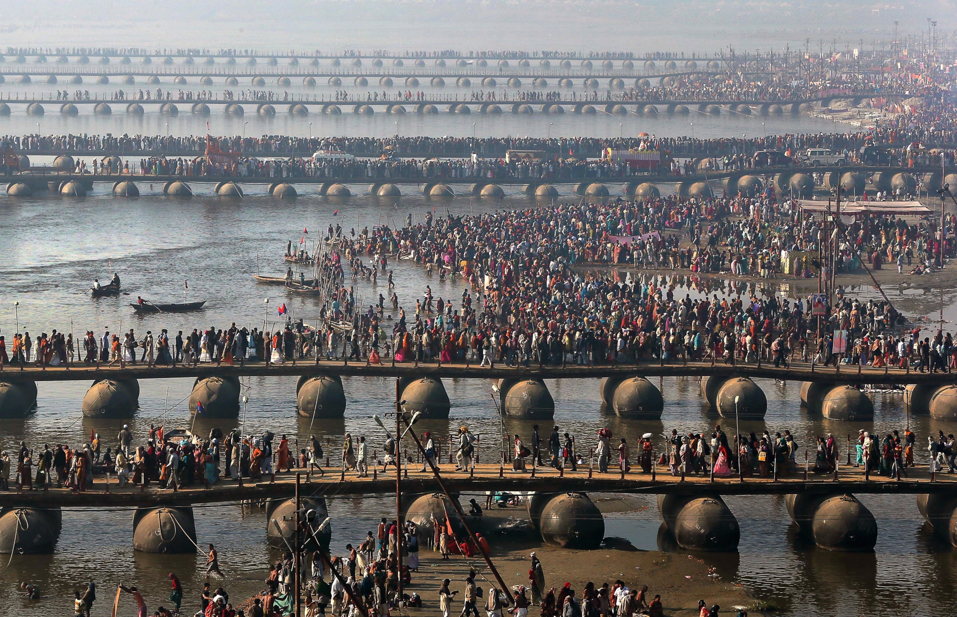 believers walking across pontoon bridges, Maha Kumbh festival