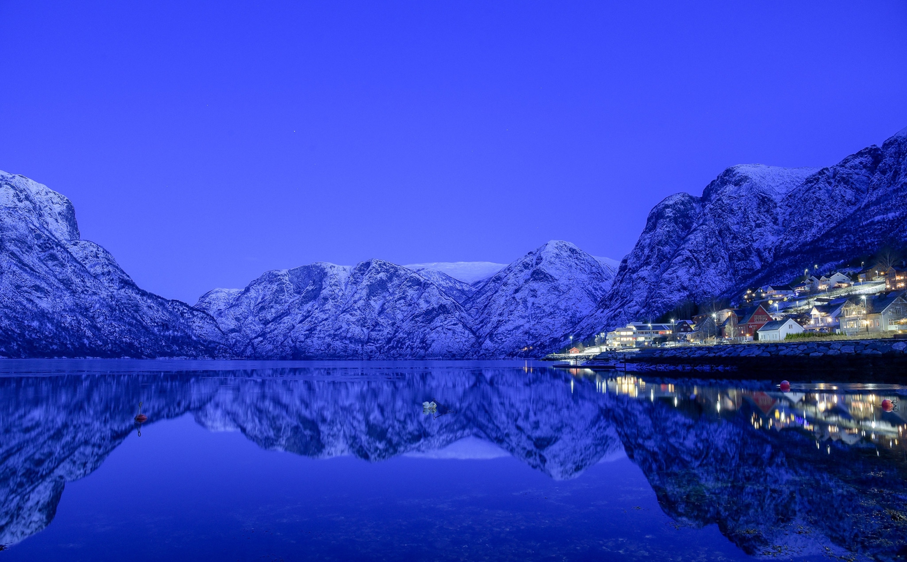 mountains reflected in the water near Naeroyfjord at dawn, Norway