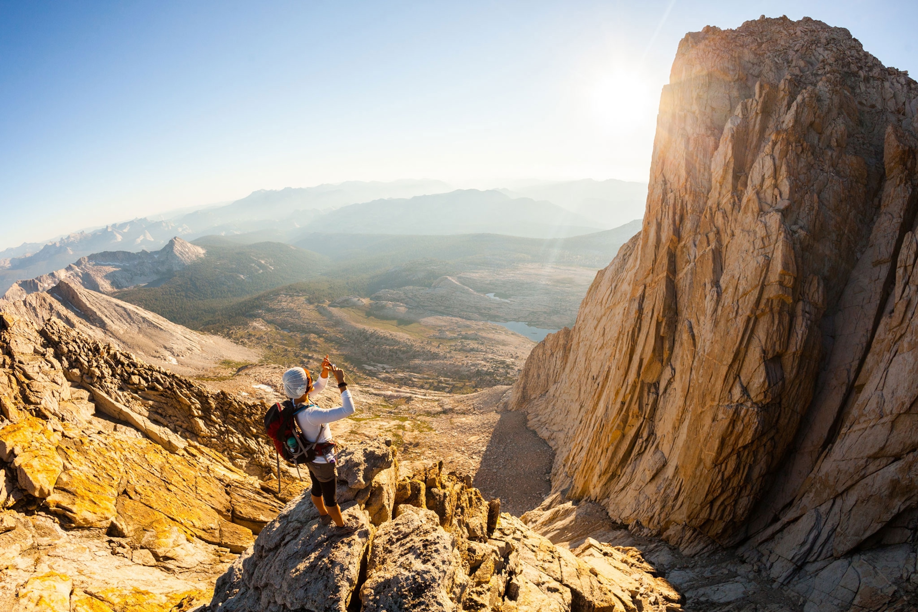 a woman in Yosemite National Park taking a picture with her camera phone
