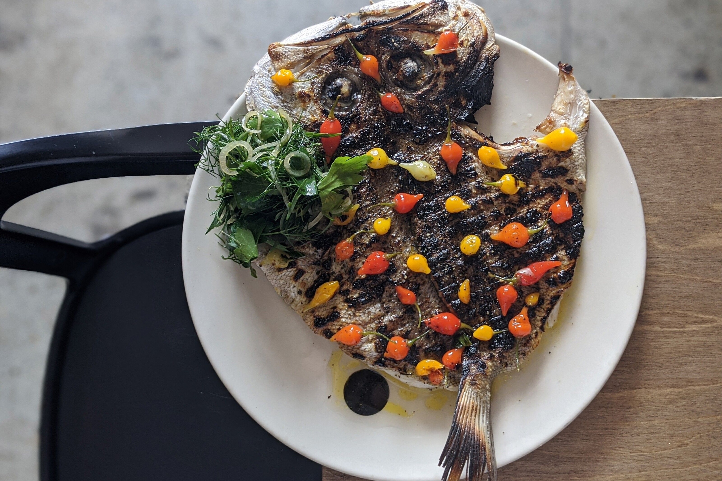 Pearl perch and charcoal biquinho peppers at Saint Peter.