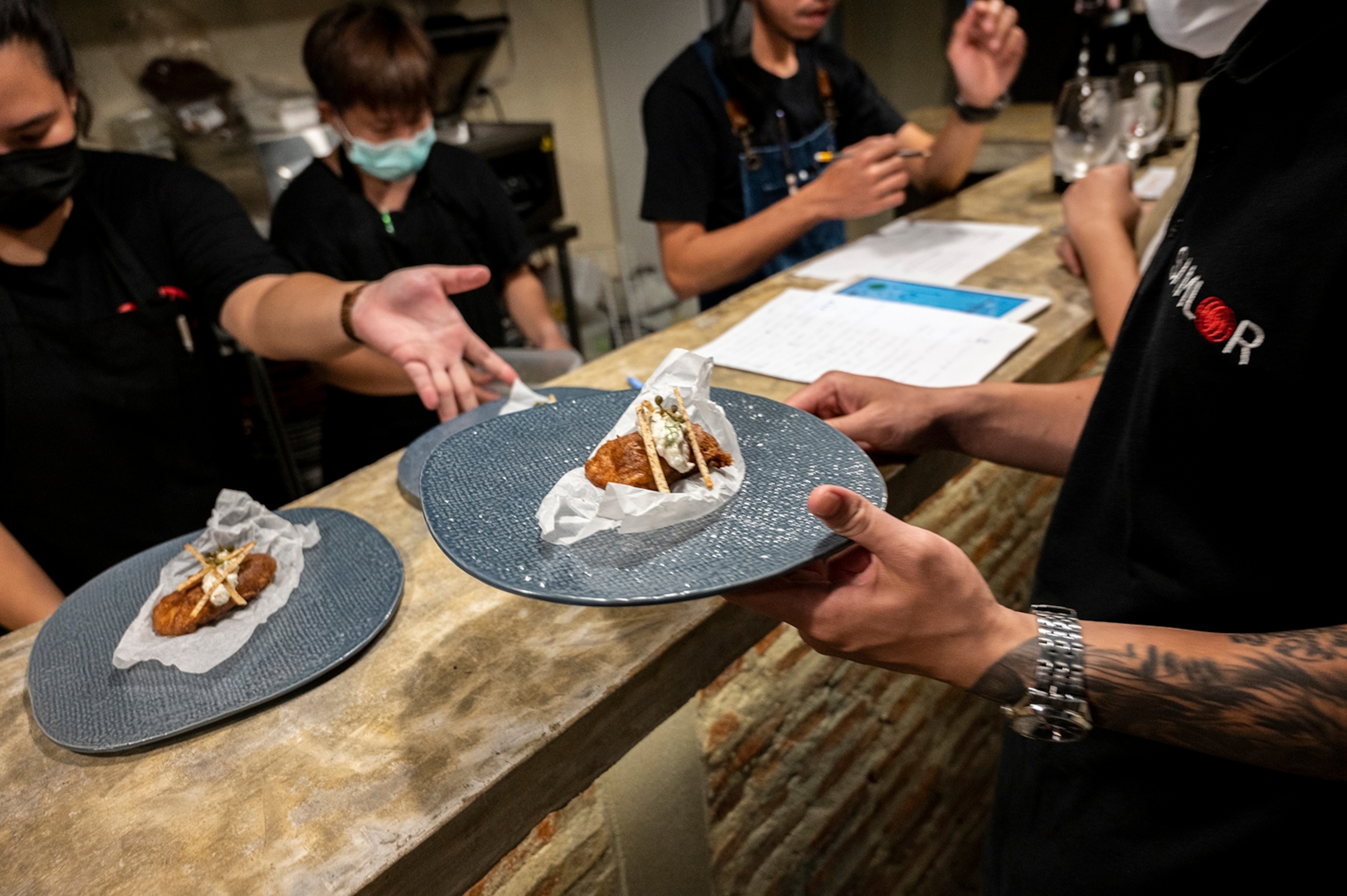 Image of loin of goatfish being prepared for service.