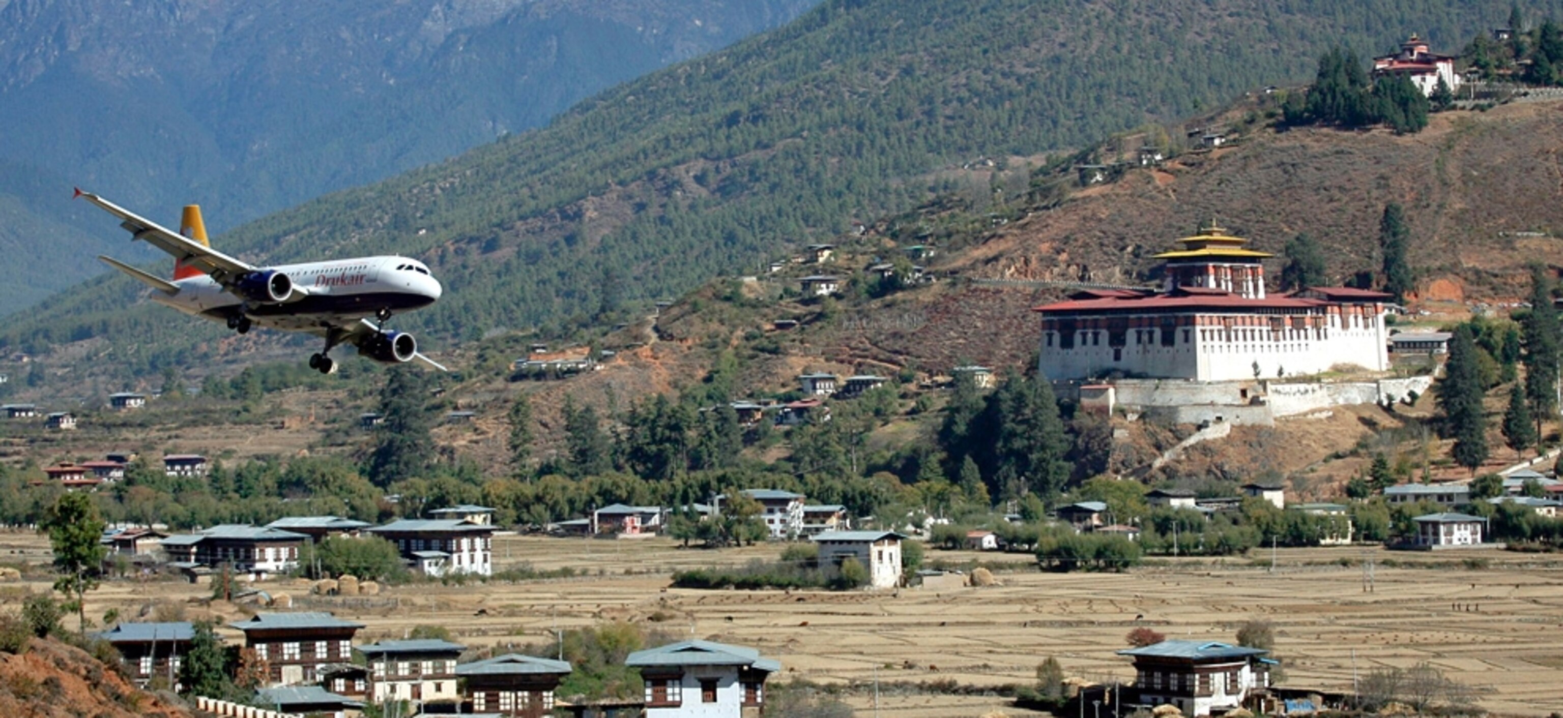 Plane landing picture: A Royal Bhutan Airlines Airbus A319-114 lands at Bhutan’s international airport in Paro, for a gallery on the world's most extreme airports