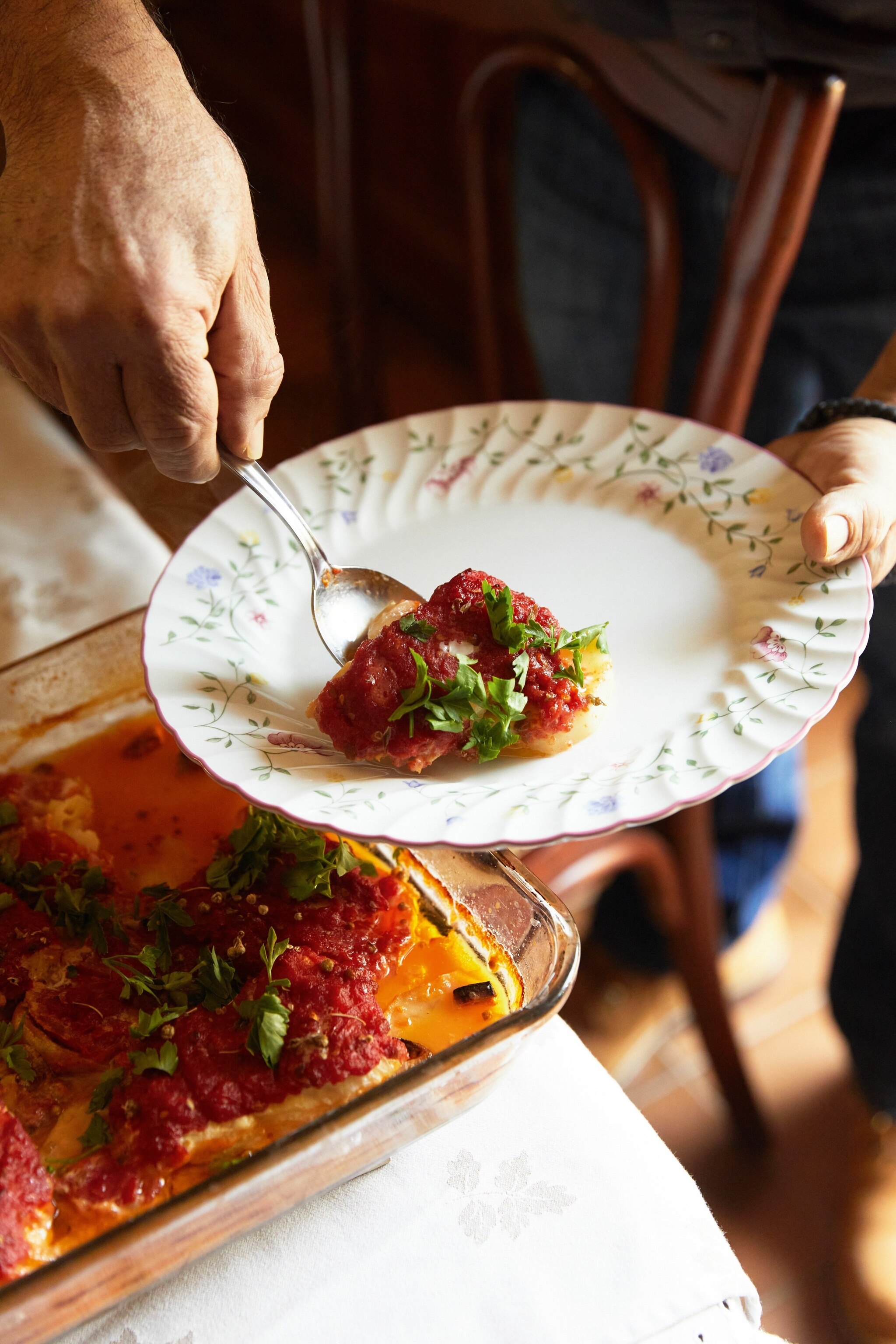 Vangelis serves a portion of psari plaki.
