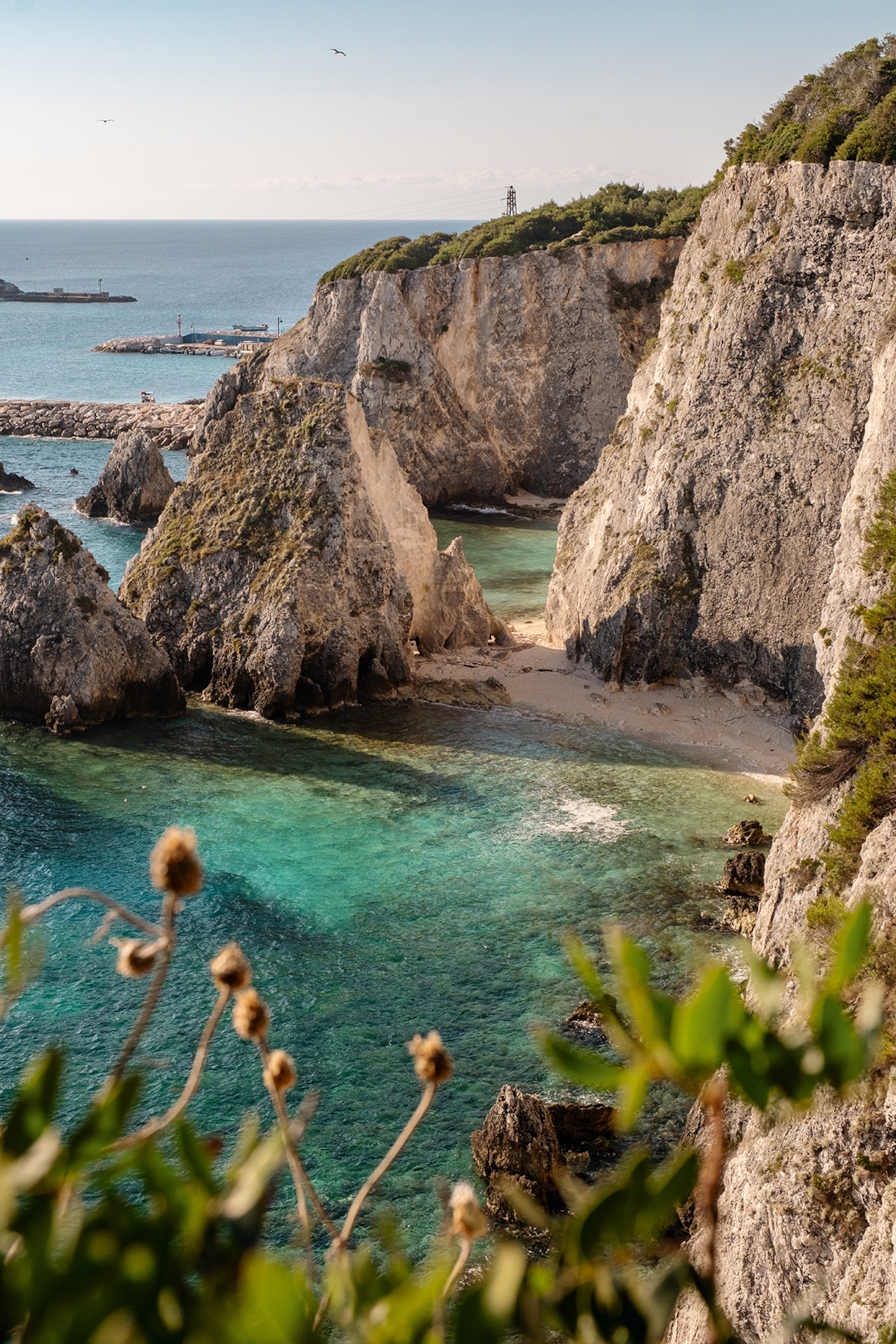 An alcove on the Puglian coast with limestone cliffs piercing from the ocean.