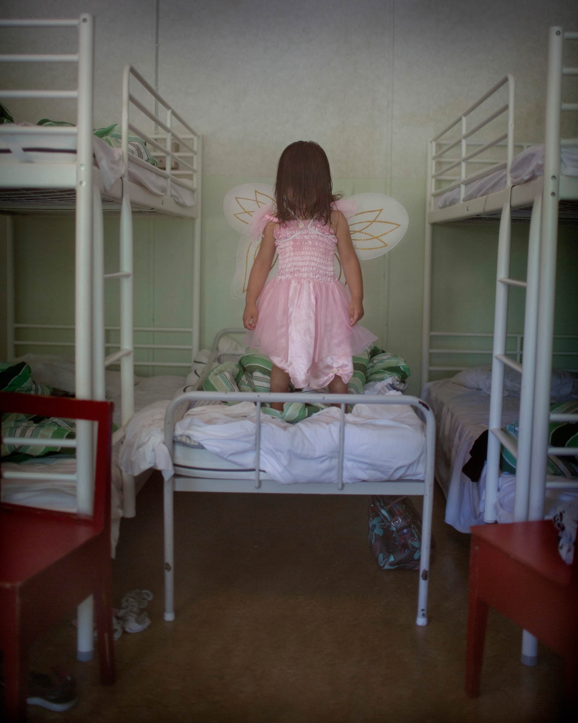 girl on bed with wings on