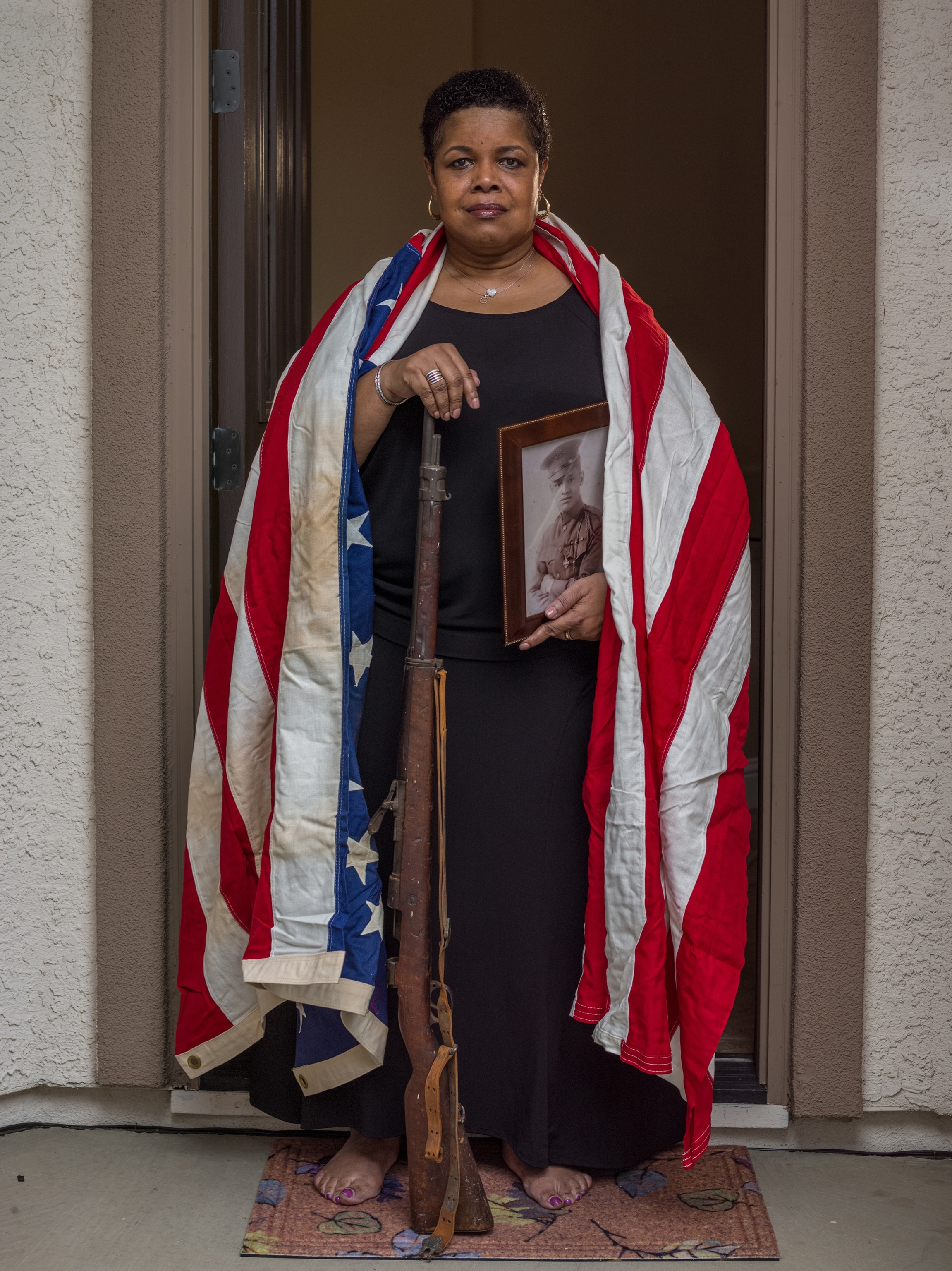 Gina McVey holding her grandfather's belongings