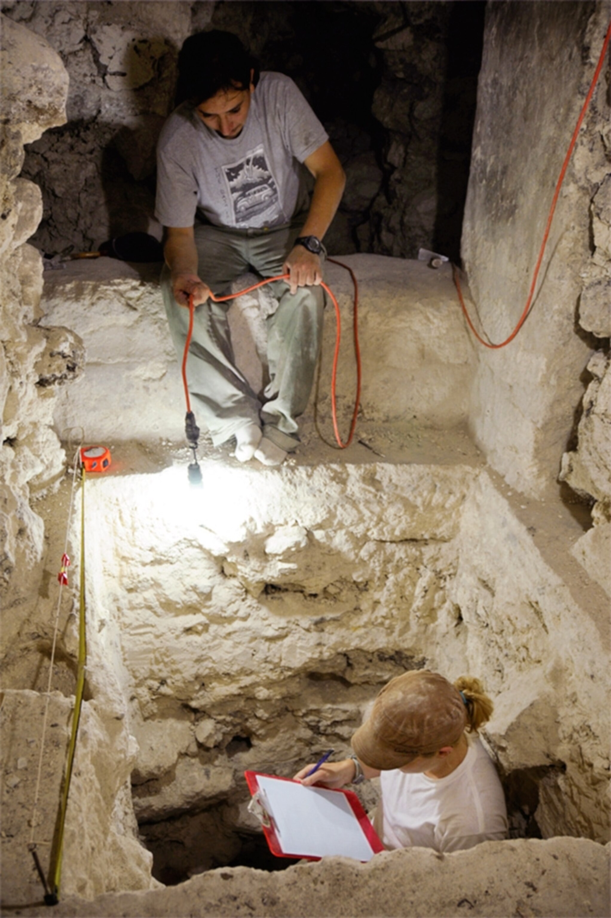 Picture of archaeologist in vault leading to new Maya royal burial chamber in Guatemala