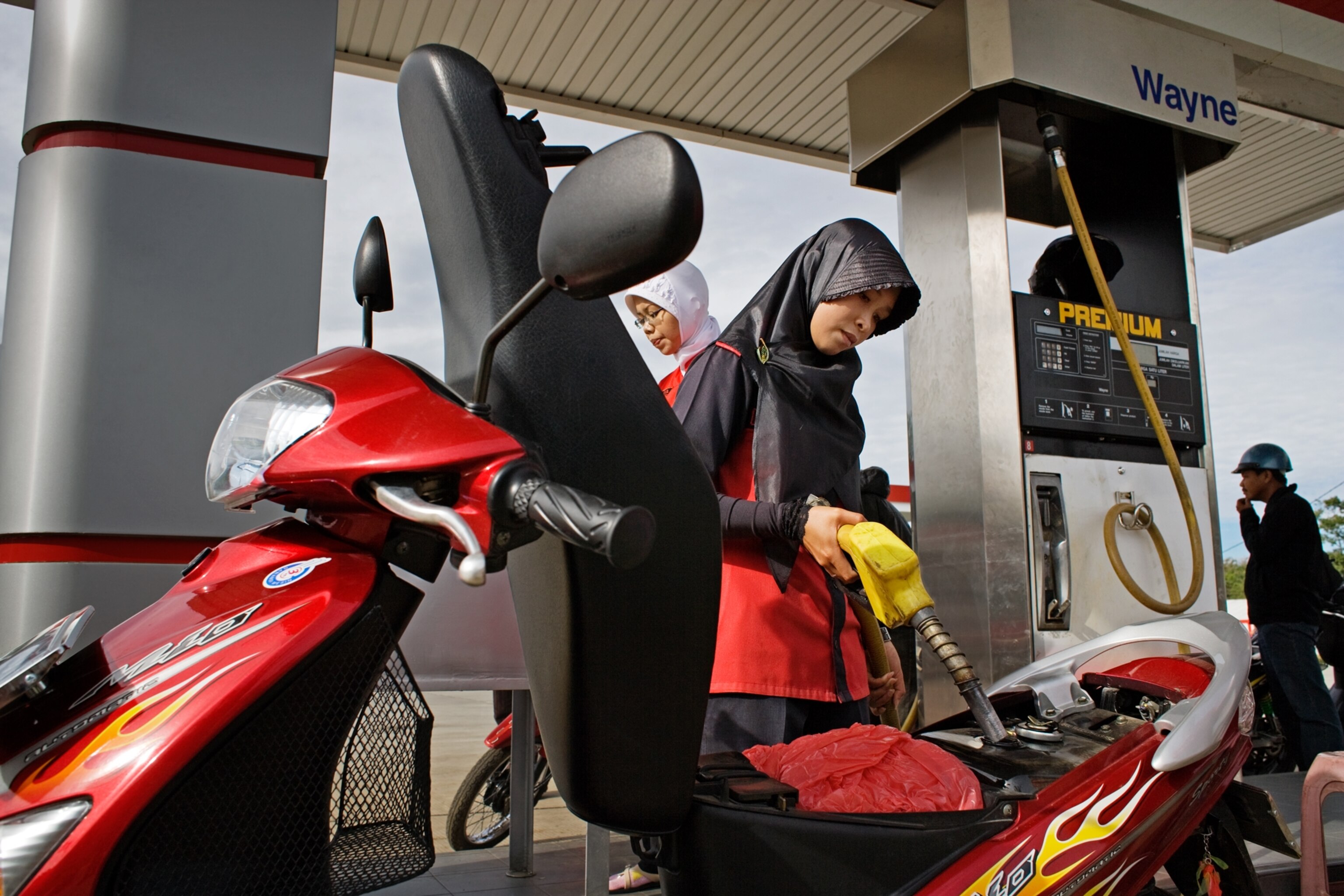women working at a West Sumatra gas station