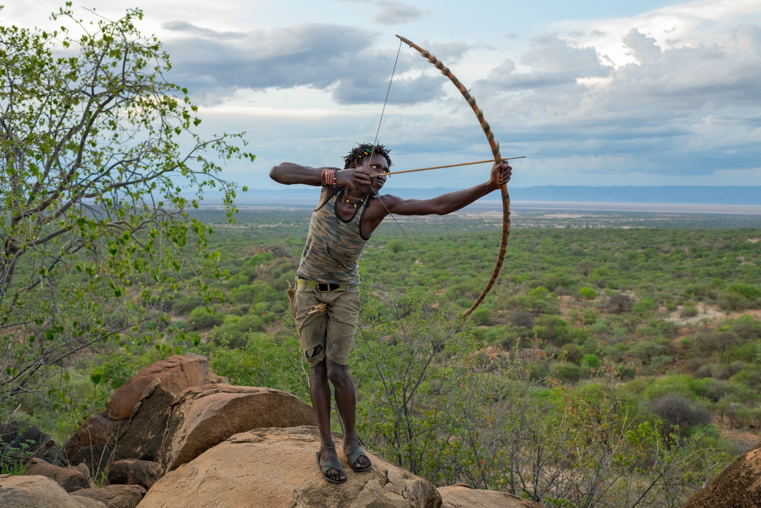 Hadza hunter-gatherers of Tanzania with bow and arrow.