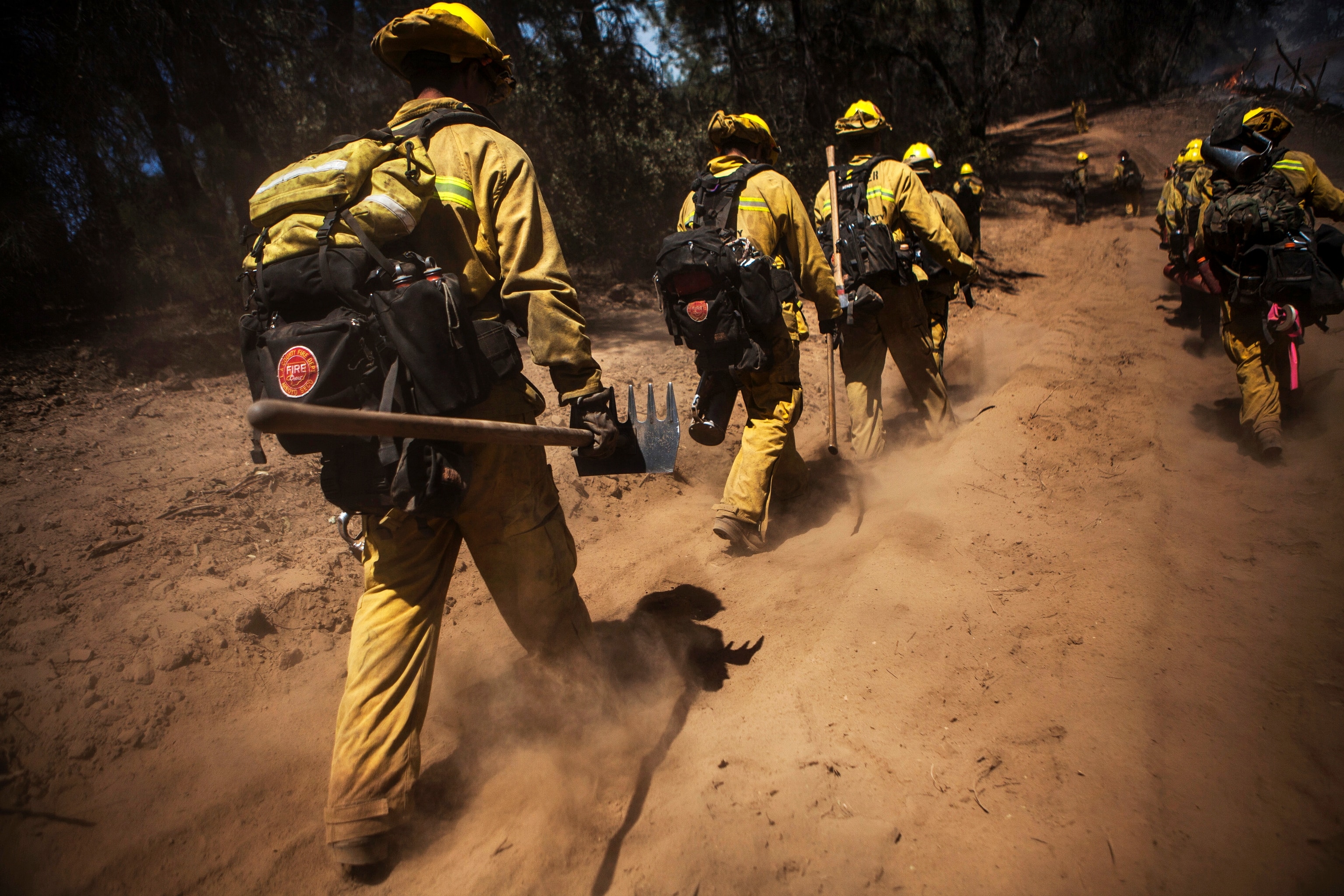 Los Angeles County firefighters walk on their way to extinguish the Rim Fire near Groveland, California, August 22, 2013.
