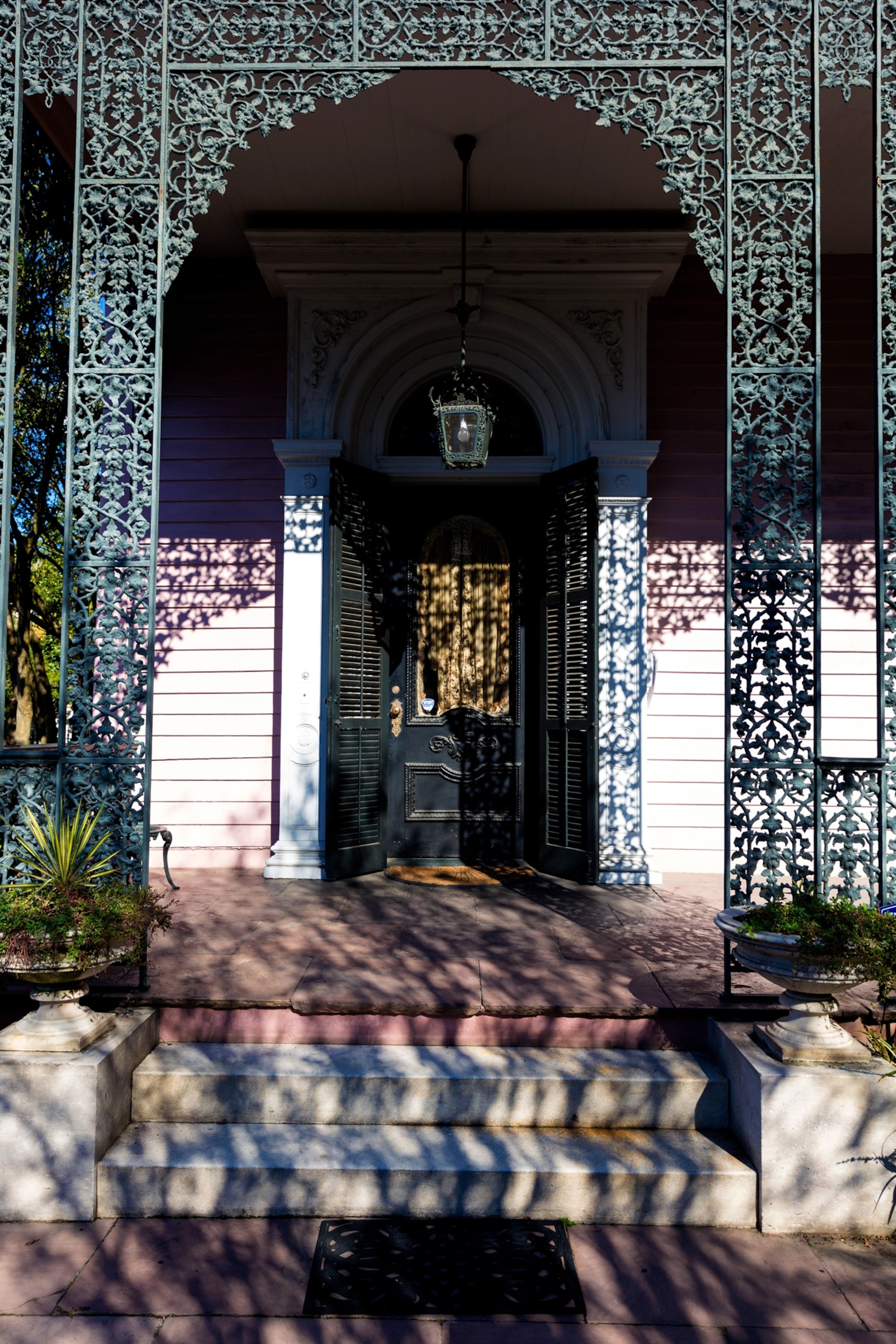 Grand mansion house with ornate lacy ironwork porch in the Garden District.