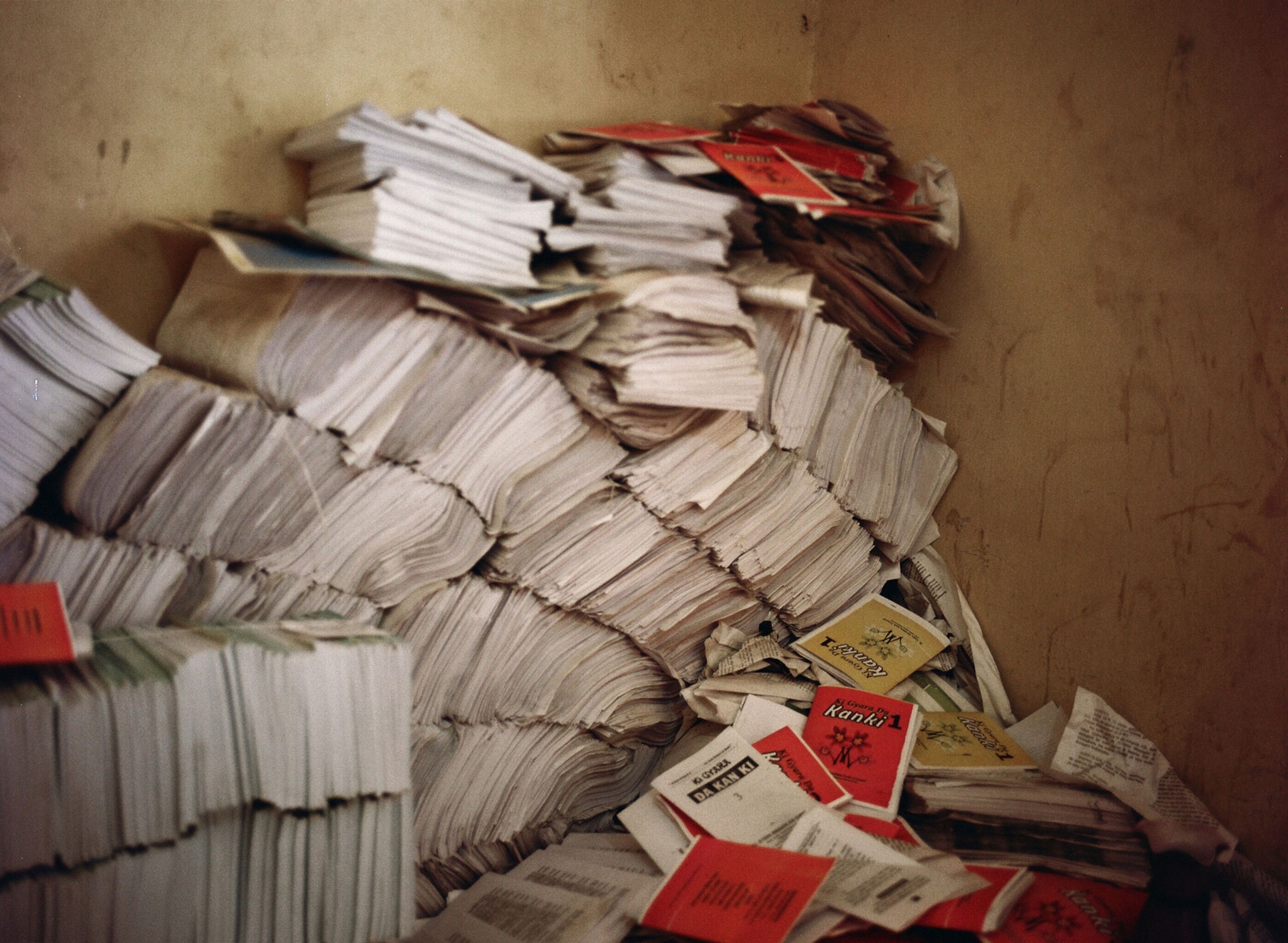 Stacks of books are piled up in a storage room in Kano before they are taken to the the market.