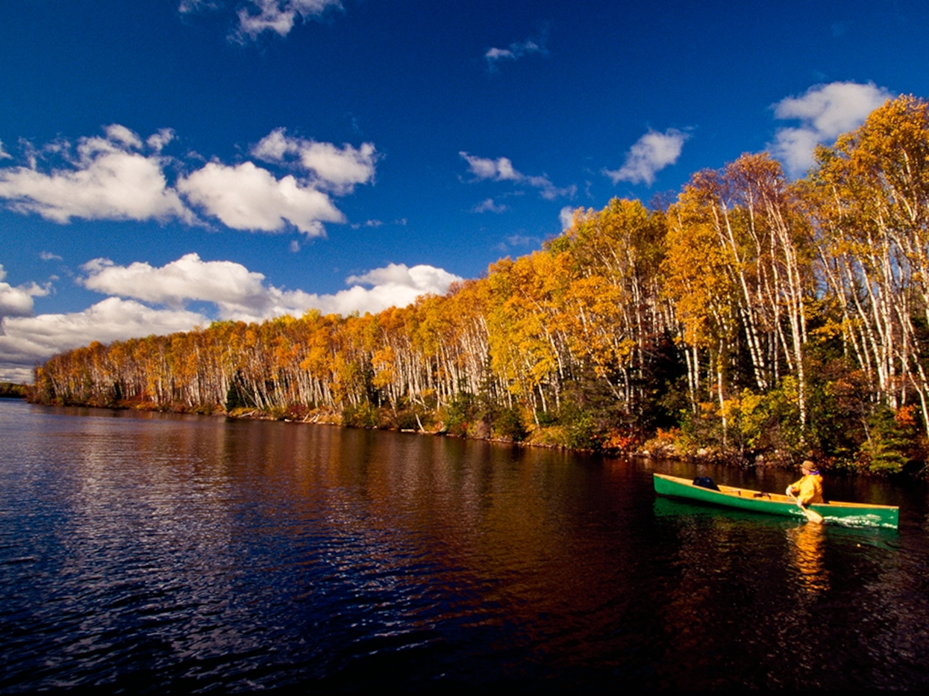 canoeist paddling along the shores of Boundary Waters, Minnesota